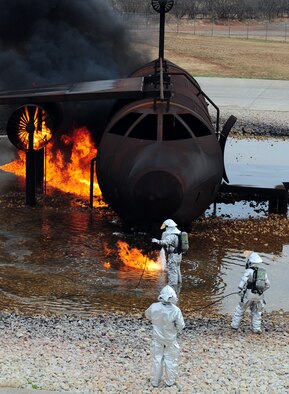 U.S. Air Force firefighters from the 7th Civil Engineer Squadron light a fire during a live fire training exercise April 2, 2014, at Dyess Air Force Base, Texas. During this live fire training, jet fuel was used to simulate the same type of fire that firefighters would encounter during an actual aircraft emergency.  (U.S. Air Force photo by Senior Airman Kia Atkins/Released)