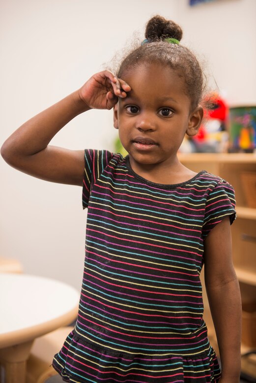 Brianna Burdett, 3 years old, salutes in honor of the Month of the Military Child at the Schriever Child Development Center. Brianna’s mother, Staff Sgt. Roshawn Burdett, works for the Air Force Technical Applications Center Detachment 46 here. (U.S. Air Force photo/Christopher DeWitt)