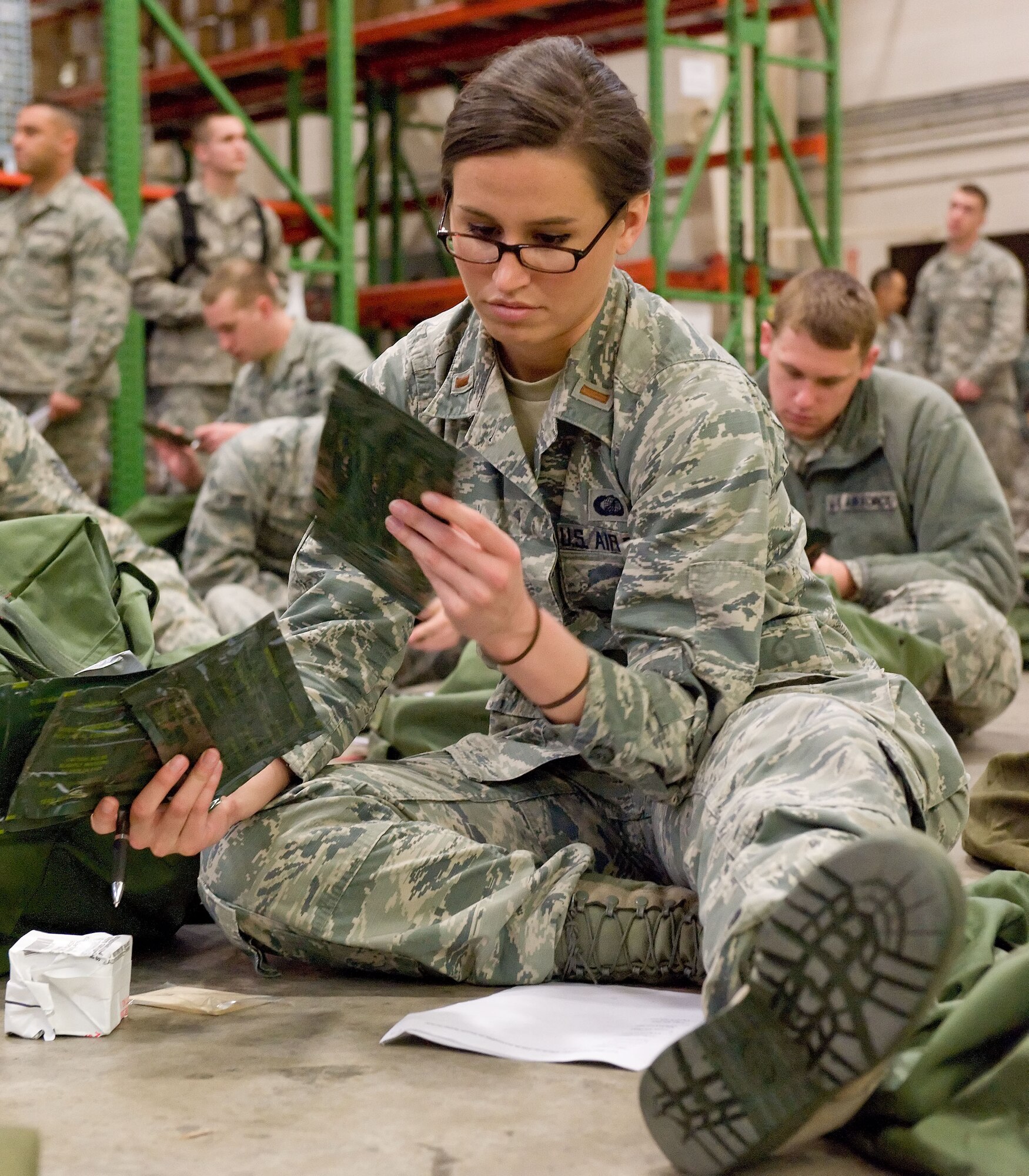 Second Lt. Allison Chermel, 436th Contracting Squadron officer in charge base operations flight, inventories items contained in one of her two deployment bags April 4, 2014, at the deployment processing line on Dover Air Force Base, Del. Chermel took part in a deployment exercise to test the readiness of Team Dover members. (U.S. Air Force photo/Roland Balik)