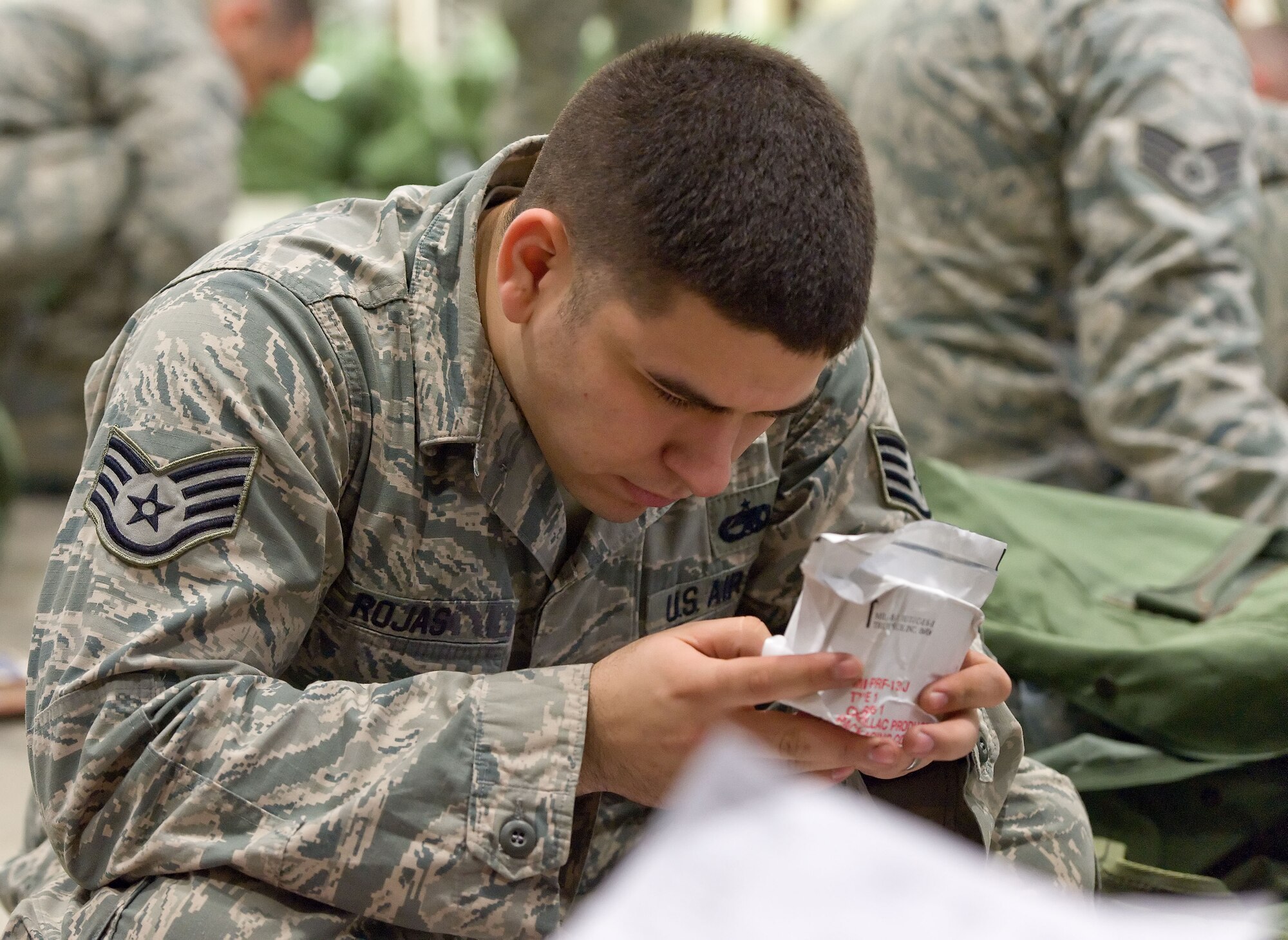 Staff Sgt. Justin Rojas, 436th Aircraft Maintenance Squadron dedicated crew chief, inventories an item contained in one of his deployment bags April 4, 2014, at the deployment processing line on Dover Air Force Base, Del. Rojas and other Team Dover members were part of the inaugural East Coast Combat Operations exercise initiated by the 436th Airlift Wing, Dover AFB. (U.S. Air Force photo/Roland Balik)