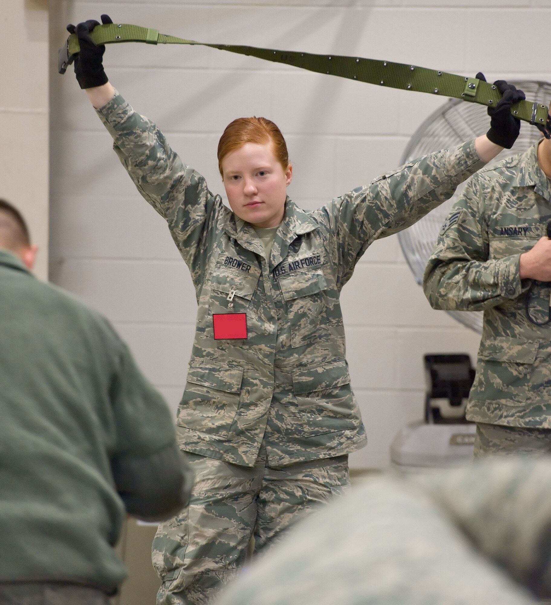 Airman 1st Class Lydia Brower, 436th Logistics Readiness Squadron mobility readiness spares packages apprentice, holds up a web belt April 4, 2014, at the deployment processing line on Dover Air Force Base, Del. Brower displayed all items contained in two deployment bags being issued to Team Dover personnel during a deployment exercise. (U.S. Air Force photo/Roland Balik)