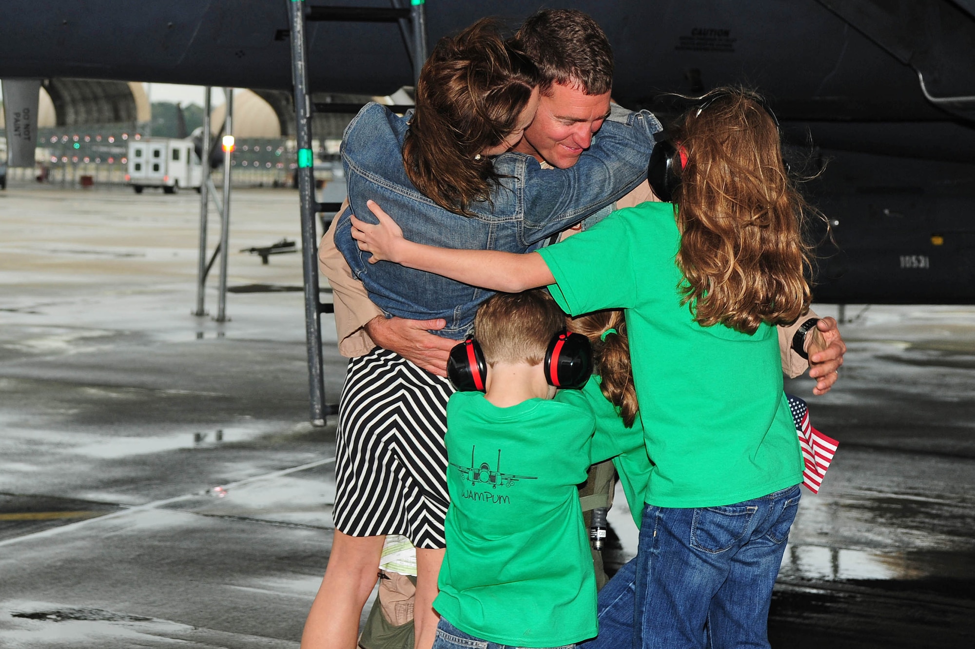 Lt. Col. Todd Dyer, 4th Fighter Wing pilot and squadron commander, reunites with his family after a deployment, April 8, 2014, at Seymour Johnson Air Force Base, N.C. Airmen assigned to the 4th FW were deployed to the 380th Air Expeditionary Wing in Southwest Asia to conduct support missions. (U.S. Air Force photo by Senior Airman John Nieves Camacho)