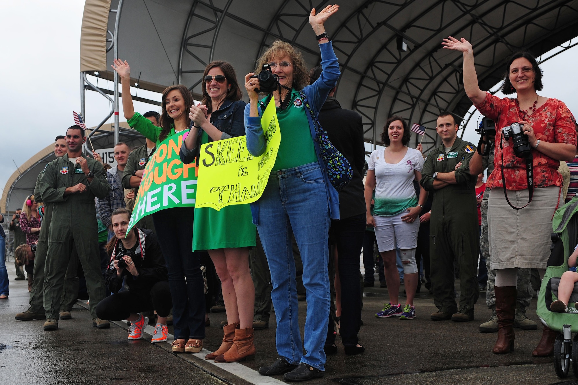 Members of Team Seymour wave as returning aircrew taxi in from a deployment, April 8, 2014, at Seymour Johnson Air Force Base, N.C. More than 200 supporters came out to welcome the returnees home. (U.S. Air Force photo by Senior Airman John Nieves Camacho)