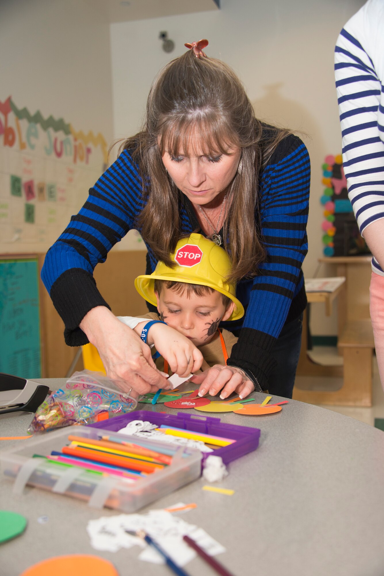 The son of Army Specialist Rusty Johnston, 112th Signal Battalion, Fort Bragg, N.C., and his “Nanna” create a construction paper caterpillar during Child Pride Day April 5, 2014, at the Youth Center, Keesler Air Force Base, Miss.  Child Pride Day is an annual event in collaboration with the month of the military child. (U.S. Air Force photo by Adam Bond)