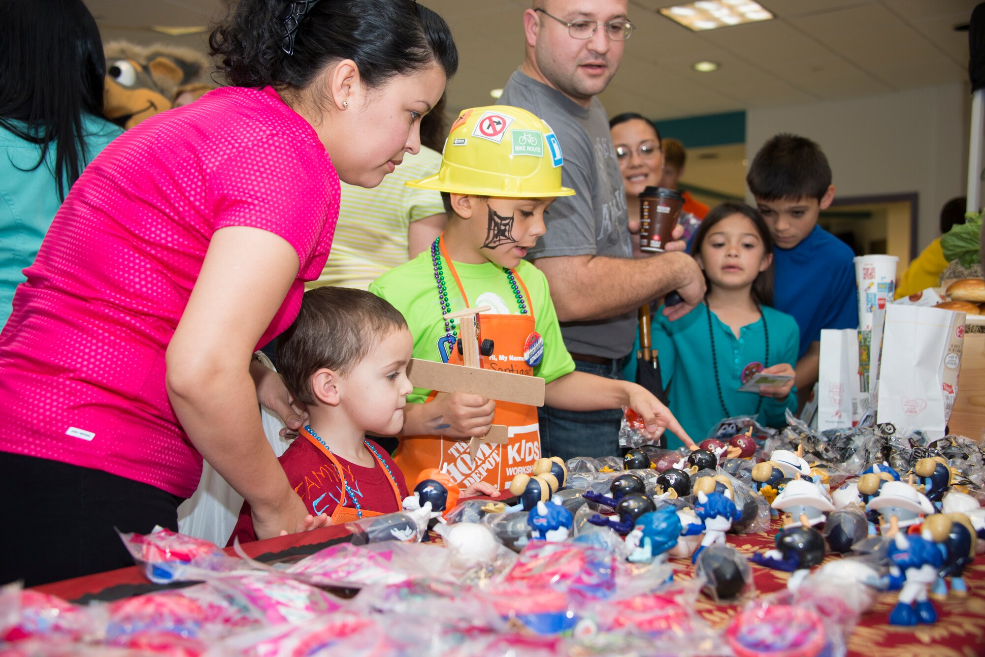 The wife and children of Capt. Ben Wright, 335th Training Squadron, check out the free toys at the McDonald’s booth during Child Pride Day April 5, 2014, at the Youth Center, Keesler Air Force Base, Miss.  Child Pride Day is an annual event in collaboration with the month of the military child. (U.S. Air Force photo by Adam Bond)