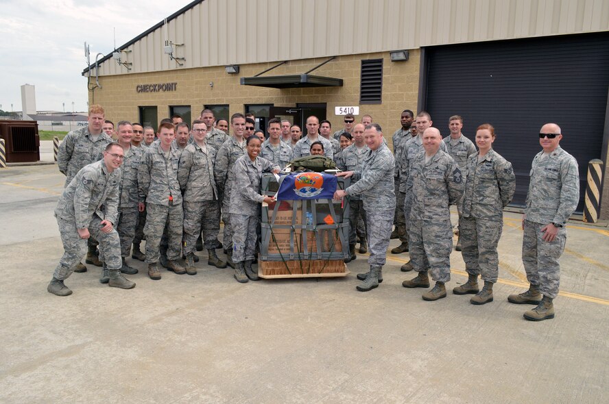 Col. E. Mark Barnes, Air Mobility Command chaplain and Chief Master Sgt. Michael T. O’Donnell, Air Mobility Command chaplain assistant functional manager, pose for a group photo with Airmen from the 3rd Aerial Port Squadron on Apr 8, 2014, during their visit to the 43rd Airlift Group, Pope Army Airfield, Fort Bragg, N.C. The 3rd Aerial Port squadron serves as the primary supporter of the XVIII Airborne Corps, as well as the 82d Airborne Division and their Global Response Force mission. Port Airmen have also been a constant force multiplier in Afghanistan and Iraq. The aerial porters bring superior job knowledge, skill and leadership to the U.S. Central Command’s area of responsibility. (U.S. Air Force photo/Marvin Krause)