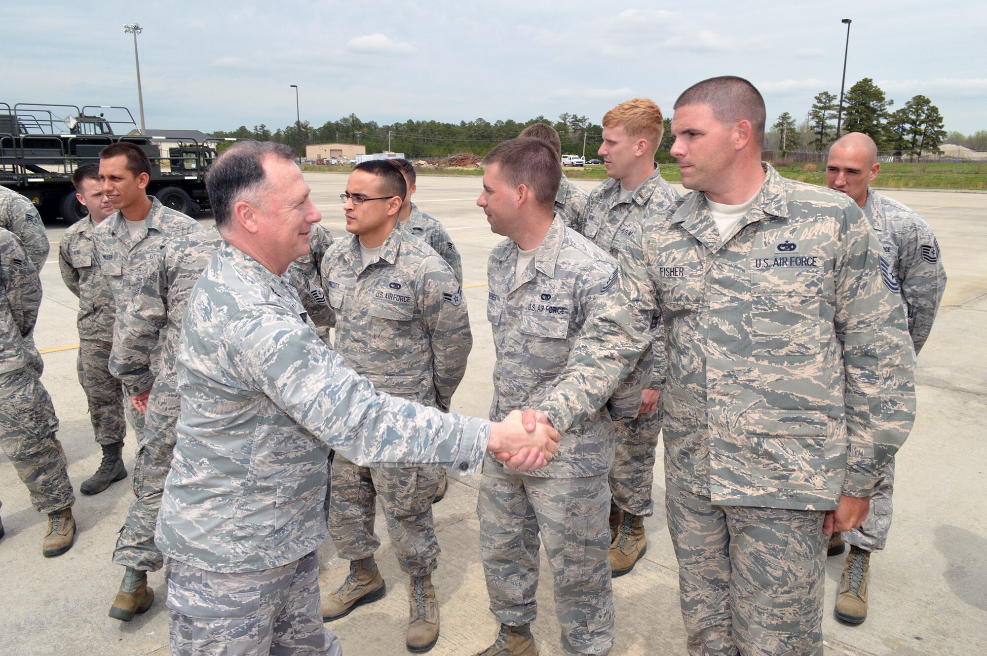Col. E. Mark Barnes, Air Mobility Command chaplain, left, shakes hands with Tech. Sgt. Brian T. Fisher, 3rd Aerial Port Squadron, during Barnes and Chief Master Sgt. Michael T. O’Donnell, Air Mobility Command chaplain assistant functional manager’s visit to the 3rd Aerial Port Squadron on Apr 8, 2014, Pope Army Airfield, Fort Bragg, N.C. The 3rd Aerial Port squadron serves as the primary supporter of the XVIII Airborne Corps, as well as the 82d Airborne Division and their Global Response Force mission. Port Airmen have also been a constant force multiplier in Afghanistan and Iraq. The aerial porters bring superior job knowledge, skill and leadership to the U.S. Central Command’s area of responsibility. (U.S. Air Force photo/Marvin Krause)