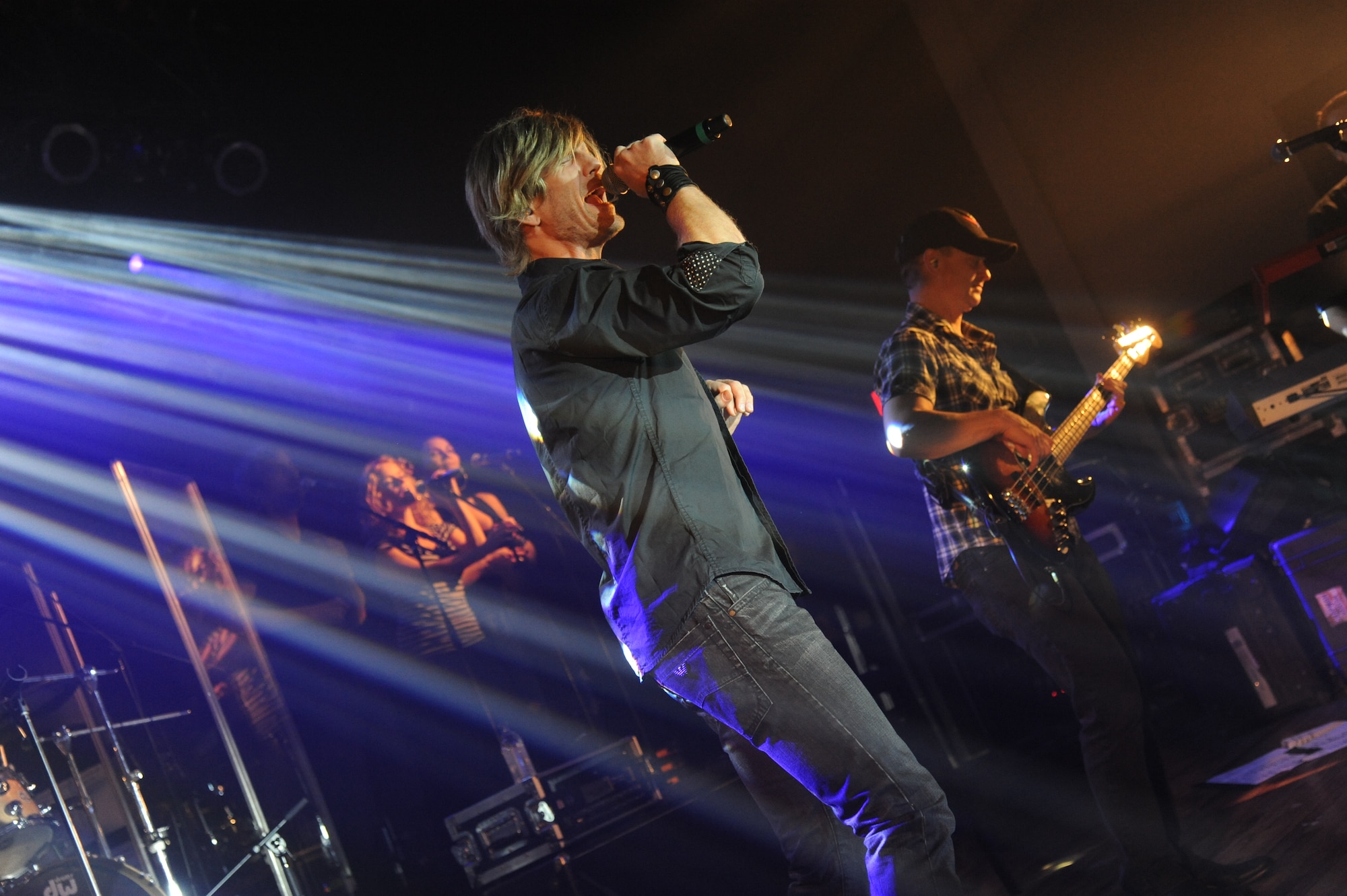 Jeff Vezain of the Gary Sinise & the Lt. Dan Band sings during a concert April 4, 2014, at the Welch Theater, Keesler Air Force Base, Miss.  The band visited Keesler during their morale-boosting 2014 USO tour of U.S. military bases.  They are also a program of the Gary Sinise Foundation, a nonprofit organization that supports and honors national defenders, veterans and first responders. (U.S. Air Force photo by Kemberly Groue)
