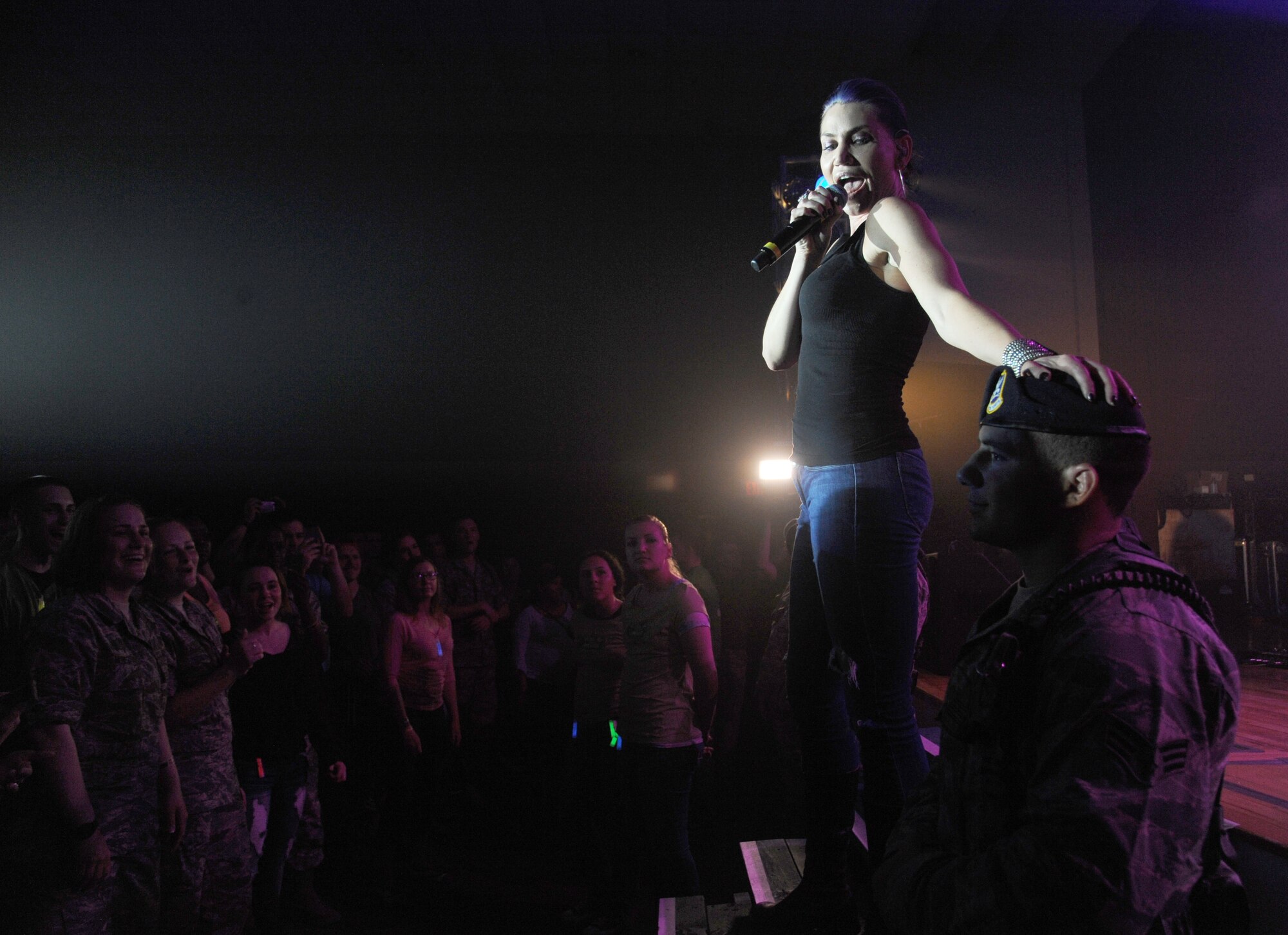 Molly Callinan of Gary Sinise & the Lt. Dan Band sings to Senior Airman Kevin Rozas, 81st Security Forces Squadron, during a concert April 4, 2014, at the Welch Theater, Keesler Air Force Base, Miss.  The band visited Keesler during their morale-boosting 2014 USO tour of U.S. military bases.  They are also a program of the Gary Sinise Foundation, a nonprofit organization that supports and honors national defenders, veterans and first responders. (U.S. Air Force photo by Kemberly Groue)