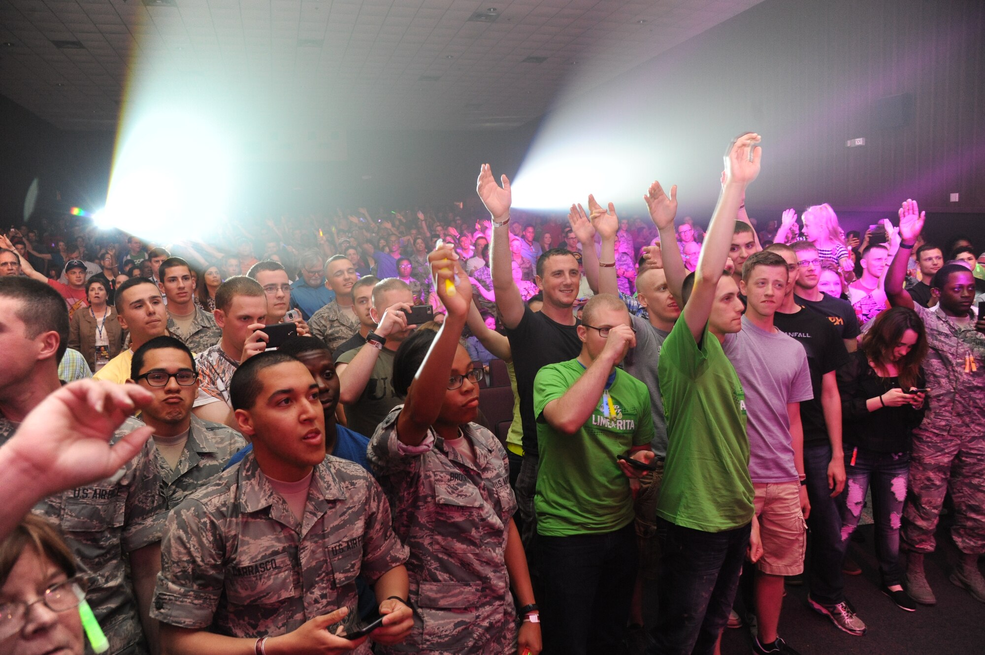 Keesler personnel stand during the stage entrance of Gary Sinise & the Lt. Dan Band during a concert April 4, 2014, at the Welch Theater, Keesler Air Force Base, Miss.  The band visited Keesler during their morale-boosting 2014 USO tour of U.S. military bases.  They are also a program of the Gary Sinise Foundation, a nonprofit organization that supports and honors national defenders, veterans and first responders. (U.S. Air Force photo by Kemberly Groue)