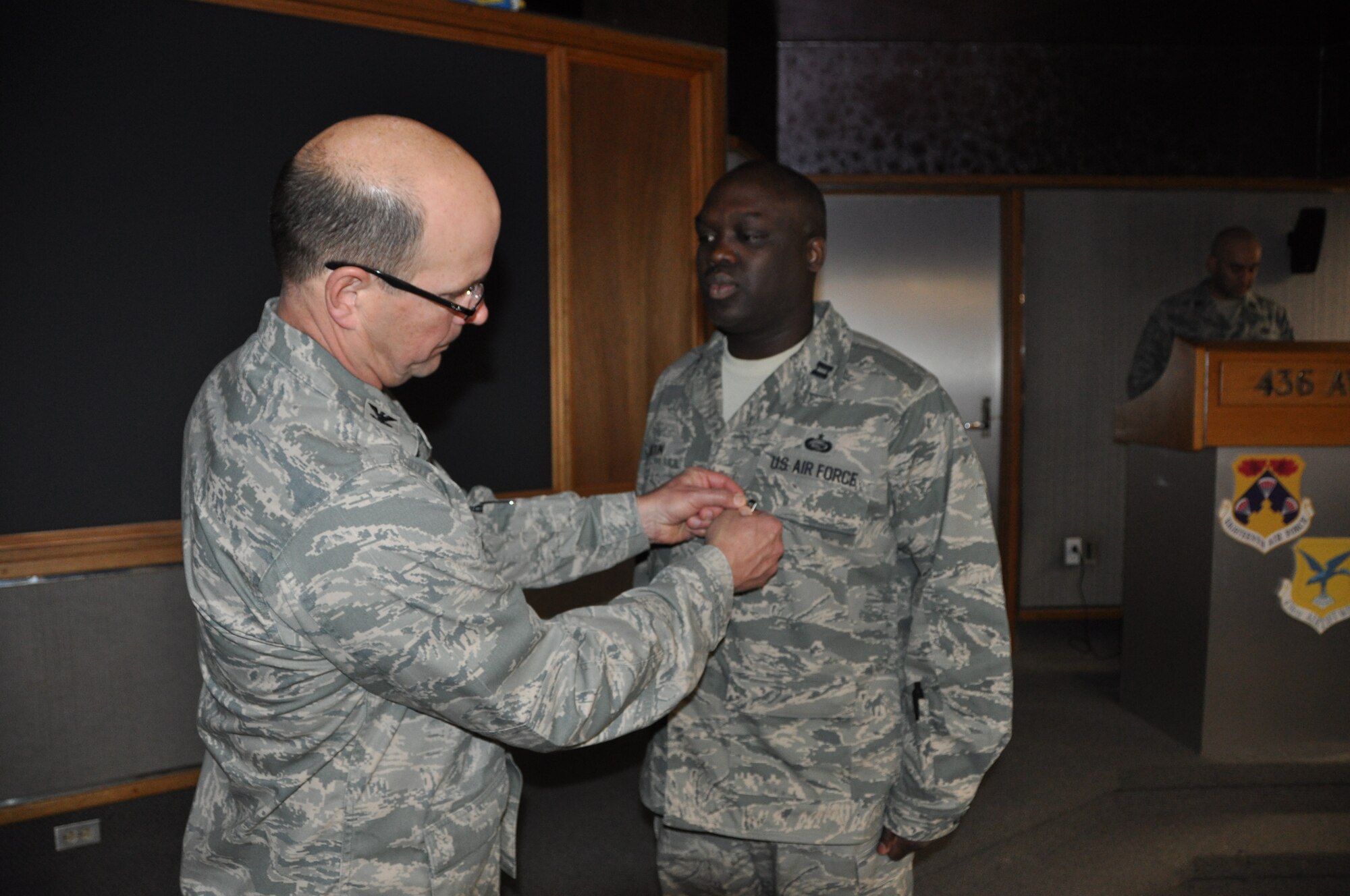 Col. Raymond A. Kozak, 512th Airlift Wing commander, pins an Air Force Commendation Medal on Capt. Theol Fadlin, 512th AW Equal Opportunity director, April 5, 2014, at Dover Air Force Base, Del. The award was in recognition of, among other achievements, the training he conducted for more than 246 Airmen on EO policies to mitigate complaints. (Air Force photo by Senior Airman Joe Yanik)