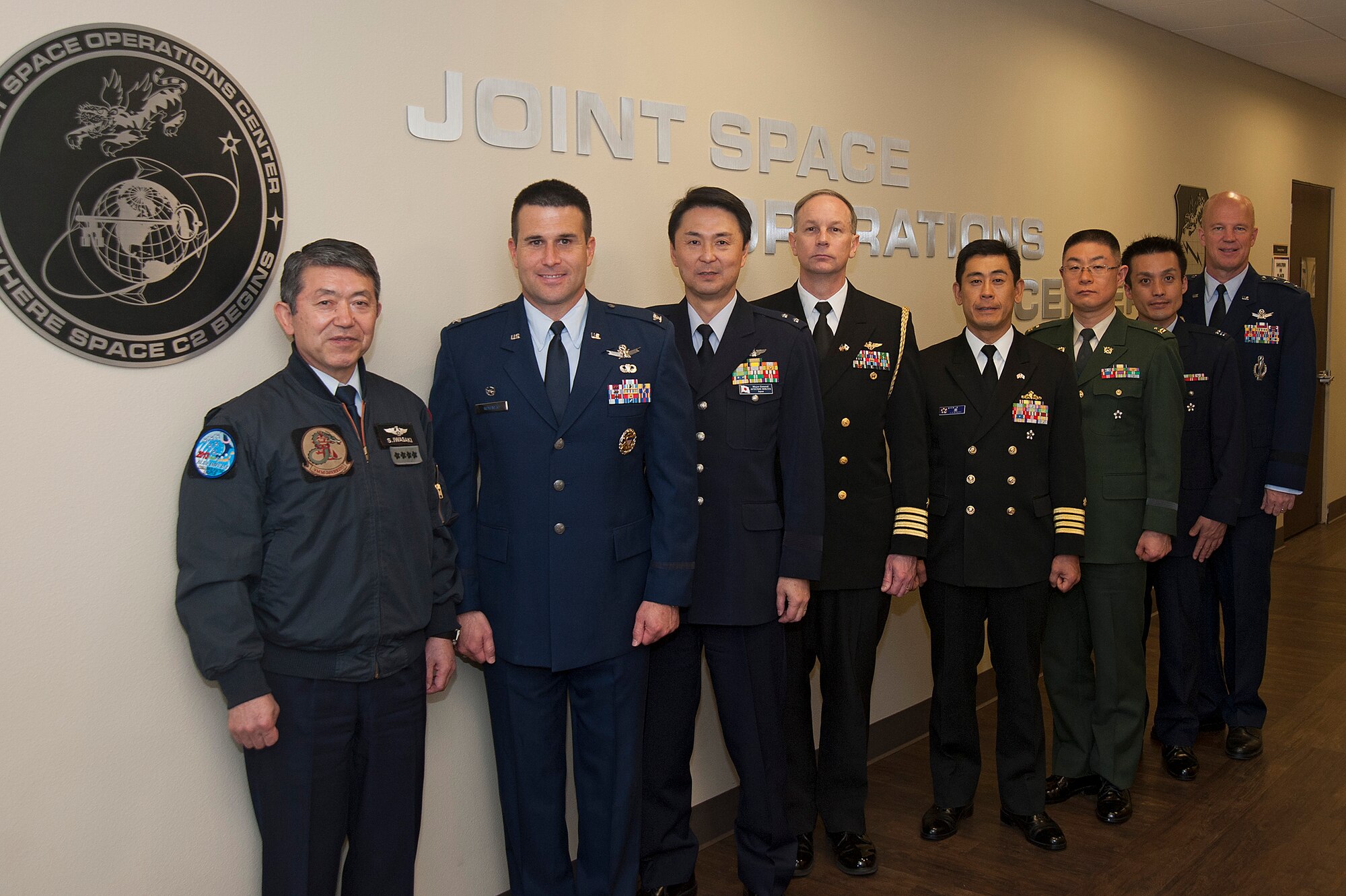 General Shigeru Iwasaki, Chief of Staff, Joint Staff Japanese Self Defense Forces, and members of his staff, pose with Col. John Wagner, 614 Air and Space Operations Center commander and Joint Space Operations Center Director, and Lt. Gen. John W. “Jay” Raymond, Joint Functional Component Command for Space and 14th Air Force commander, inside the JSpOC, April 1, 2014, Vandenberg Air Force Base, Calif. General Iwasaki, his wife and members of his senior staff visited Vandenberg to learn more about the mission of the 14th Air Force and 30th Space Wing. (U.S. Air Force Photo/Michael Peterson)