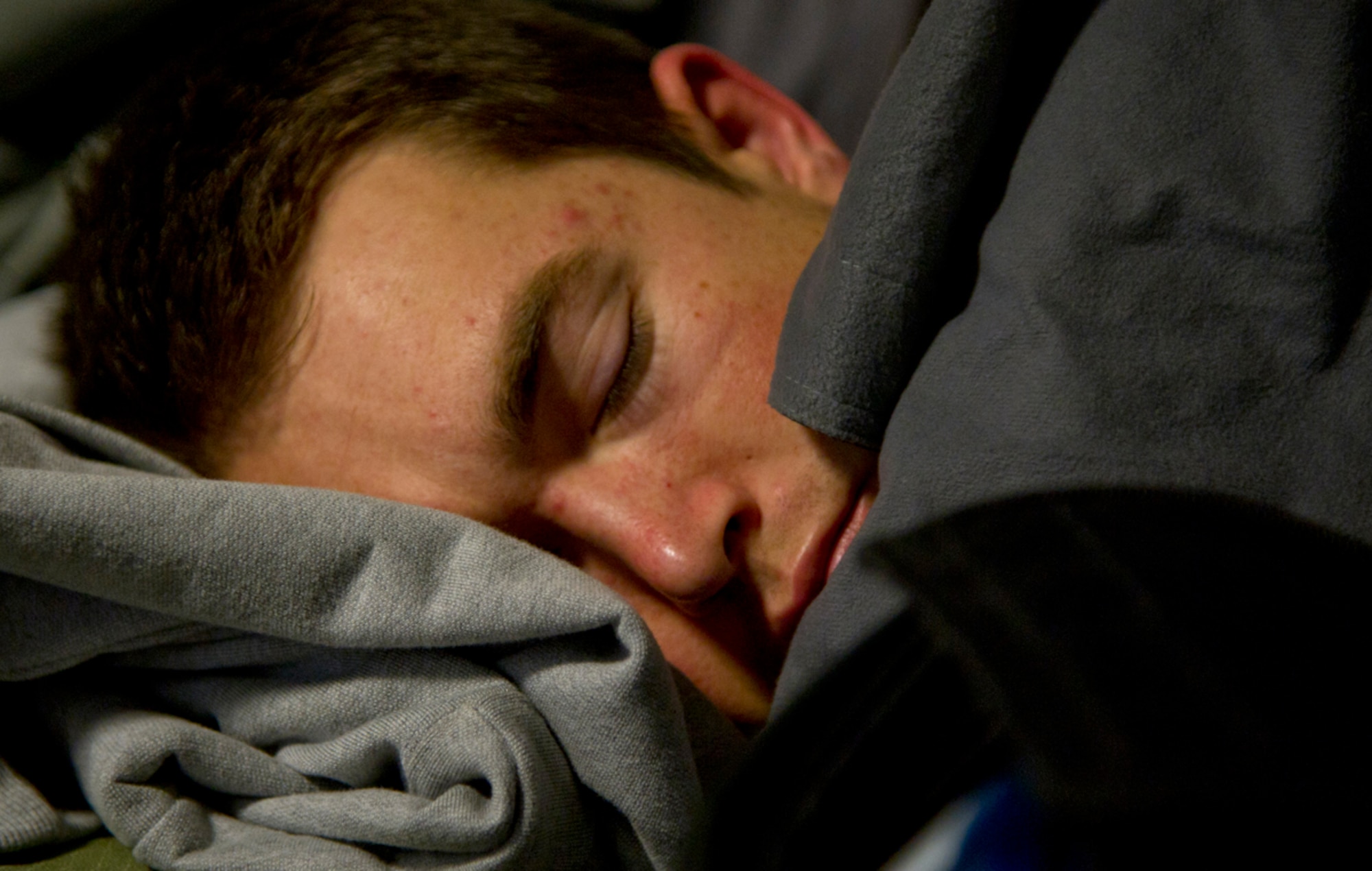 Air Force Staff Sgt. Travis Hunt, 3rd Air Support Operations Squadron joint tactical air controller, sleeps after running laps inside the Alaska Dome in Anchorage Friday during the Tactical Air Control Party Association’s annual 24-hour Challenge Run. Twenty-eight members of the 3rd ASOS and families ran a total of 769 miles in the 24-hour period. (U.S. Air Force photos/Staff Sgt. Sheila deVera)
