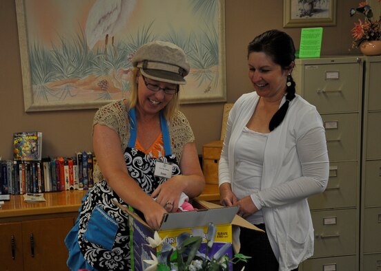 Susan Hoversten and Cheryl Yarbrough, Airman’s Attic volunteers, sort through new donations together April 8 at the Airmen and Family Readiness Center. The Attic receives donations to give Airmen free of charge. (U.S. Air Force photo by Airman 1st Class Solomon Cook)