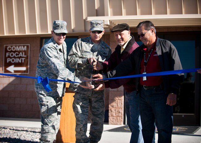 (from left to right) U.S. Air Force Col. Charles Perham, 99th Mission Support Group commander, Col. Barry Cornish, 99th Air Base Wing commander, Peter Pupparo, U.S. Army Corps of Engineers resident engineer, and Danny Fonseca, U.S. Army Corps of Engineers construction representative, cut a ribbon April 1, 2014, at Nellis Air Force Base, Nev.  The ribbon cutting ceremony signifies the opening of the new 99th Communications Squadron Network Control Center. (U.S. Air Force photo by Airman 1st Class Jake Carter)