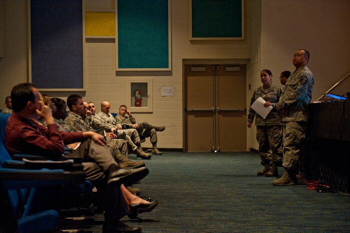 Master Sgt. Rachel Crittle, 99th Force Support Squadron military personnel section superintendent, answers questions during a force management town hall meeting April 3, 2014 at Nellis Air Force Base, Nev. Representatives from multiple organizations on base were present to answer questions regarding the effects force management  will have on their organizations. (U.S. Air Force photo by Airman 1st Class Timothy Young)