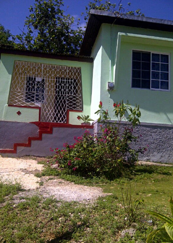 U.S. Air Force Master Sgt. Kenry Peart, 633rd Communications Squadron knowledge operations section chief, visits his childhood home in the Parish of Manchester, Jamaica every two years. Peart and his family continue to make improvements to the house by adding addition, indoor plumbing and a solar-powered water heater. (Courtesy photo)