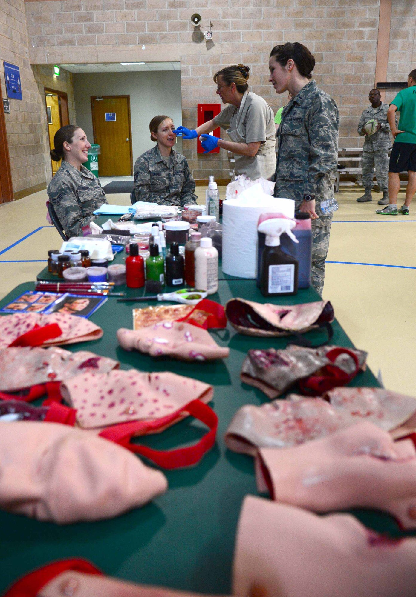 The triage realistic makeup station paints the faces of willing participants
during the Helping Agency Team's bi-annual "Wellness Block Party". (U.S. Air Force photo by Senior Airman Desiree W. Moye)