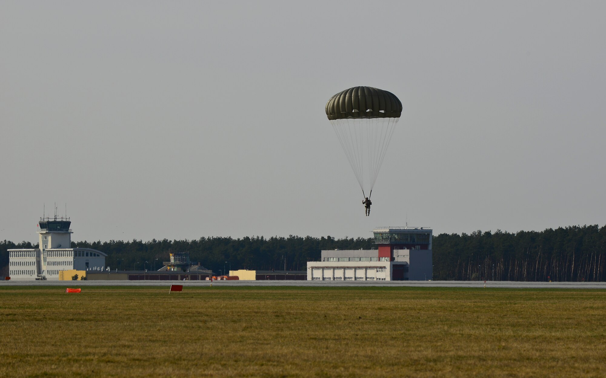 United States and Polish service members jump from U.S. C-130J Super Hercules to conduct static-line and high altitude low-level jumps on Powidz Air Base, Poland, April 2, 2014. Polish land and special operations forces jumped from U.S. aircraft with a joint team of U.S. jumpmasters. During the aircraft rotation, allied forces worked together to increase interoperability through various exercises, including static-line and high altitude low-level jumps, container delivery system bundle drops, grass-strip tactical landings and observation flights.  (U.S. Air Force Photo/Tech. Sgt. Daylena S. Ricks)