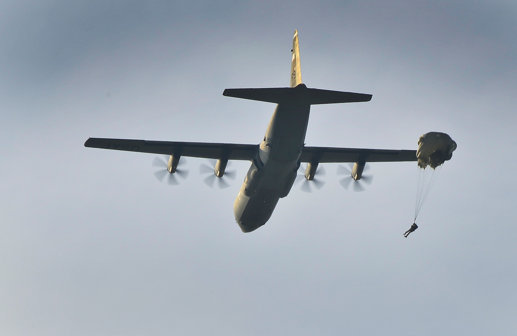 United States and Polish service members repel after jumping from a U.S. C-130J Super Hercules to conduct static-line and high altitude low-level jumps on Powidz Air Base, Poland, April 2, 2014. Polish land and special operations forces jumped from U.S. aircraft with a joint team of U.S. jumpmasters. During the aircraft rotation at the U.S. Aviation Detachment in Poland, allied forces worked together to increase interoperability through various exercises, including static-line and high altitude low-level jumps, container delivery system bundle drops, grass-strip tactical landings and observation flights.  (U.S. Air Force Photo/Tech. Sgt. Daylena S. Ricks/Released)