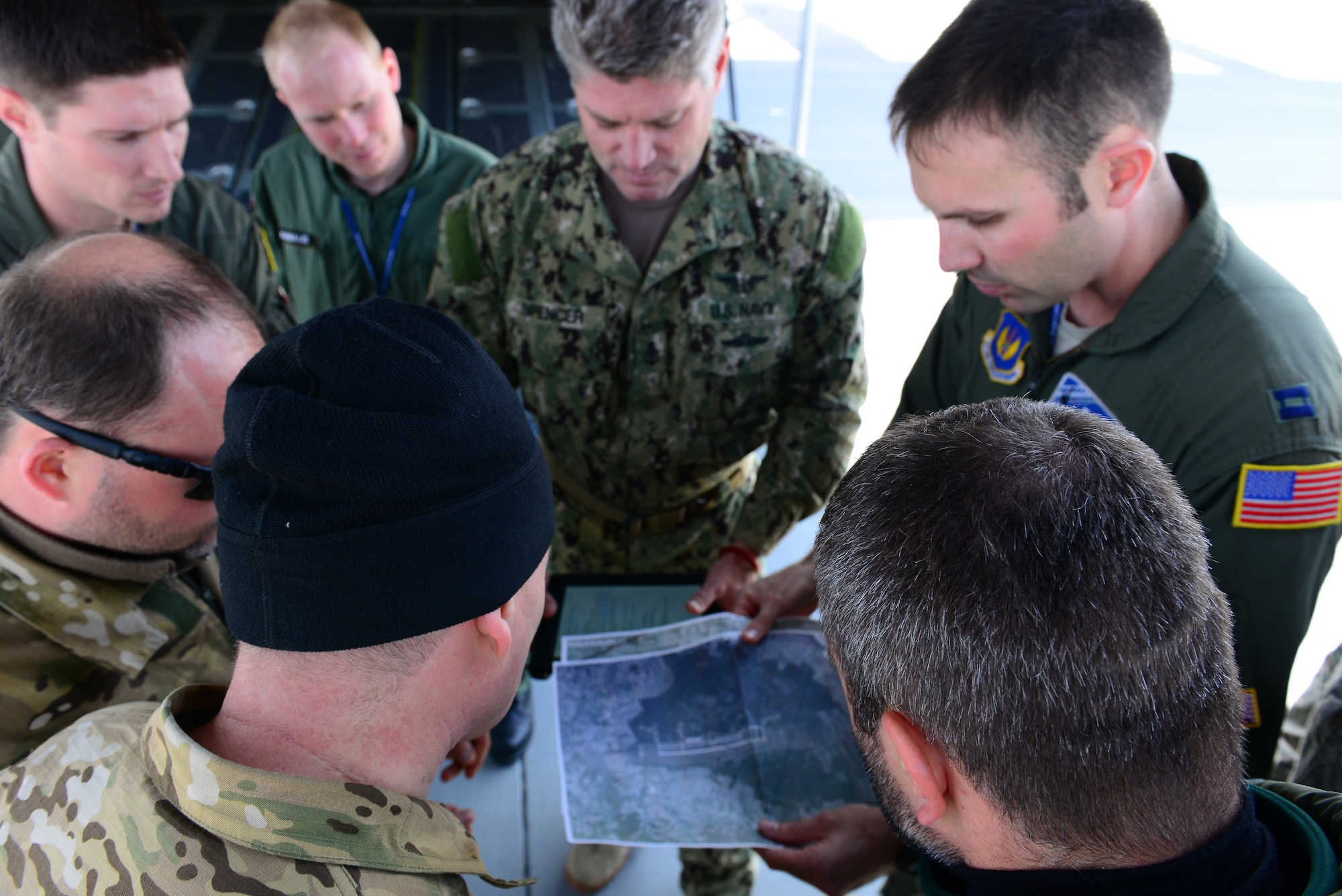 United States Air Force Capt. Sean McKee of 37th Airlift Squadron, Ramstein Air Base, Germany, U.S. C-130J Super Hercules pilot, meets with U.S. and Polish paratroopers before they conduct static-line and high altitude low-level jumps at Powidz Air Base, Poland, April 2, 2014. Polish land and special operations forces jumped from U.S. aircraft during training with a joint team of U.S. jumpmasters. During the aircraft rotation at the U.S. Aviation Detachment in Poland, allied forces worked together to increase interoperability through various exercises, including static-line and high altitude low-level jumps, container delivery system bundle drops, grass-strip tactical landings and observation flights.  (U.S. Air Force Photo/Tech. Sgt. Daylena S. Ricks/Released)