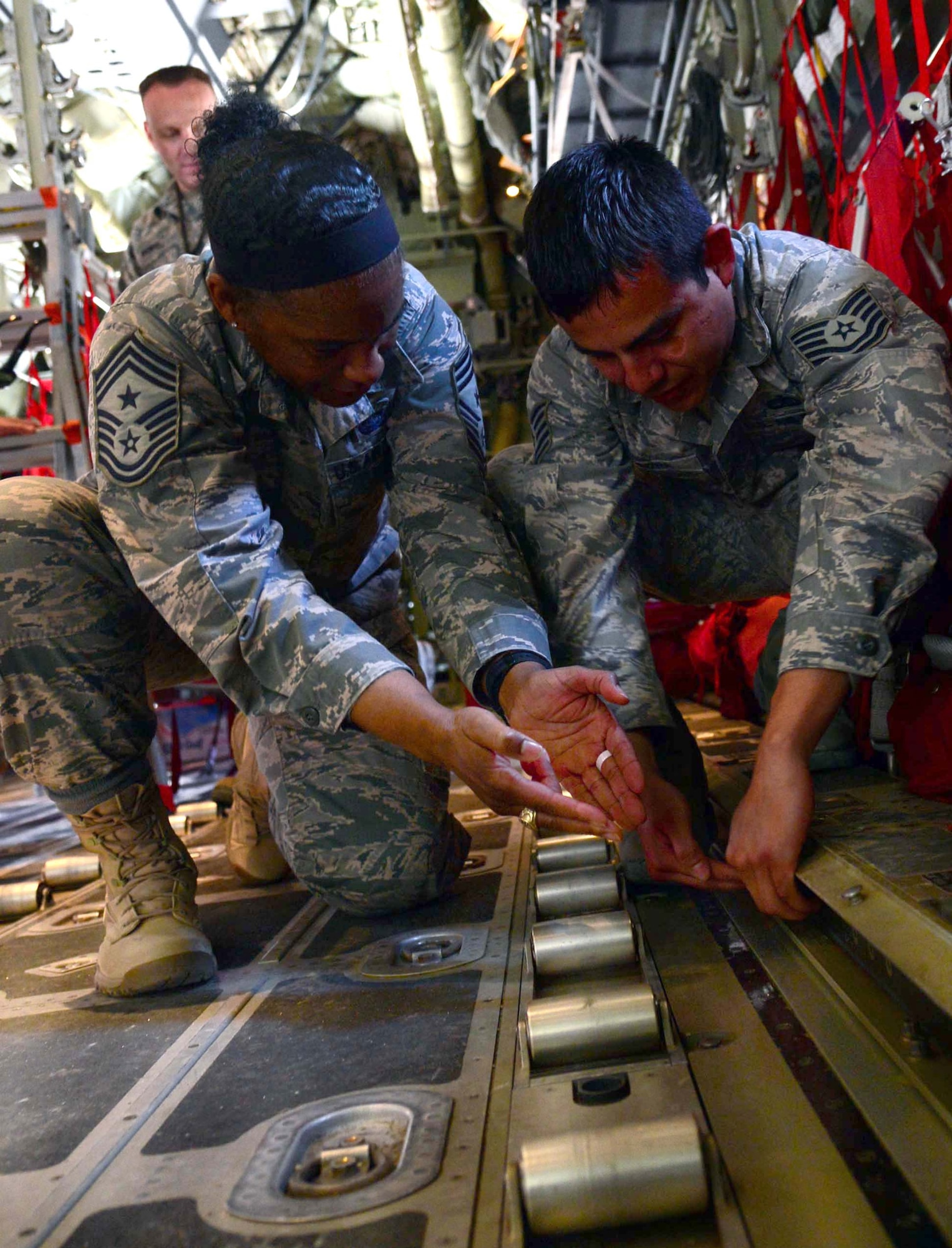 Tech. Sgt. Miguel Corona, 386th Expeditionary Aircraft Maintenance Squadron
C-130J crew chief, briefs Air Forces Central Command Chief Master Sgt.
Shelina Frey on the rolling surface components and how cargo efficiently
moves on and off the aircraft during her farewell tour of the 386th Air
Expeditionary Wing at an undisclosed location in Southwest Asia. Frey met
and recognized numerous Airmen for their continuous service to the U.S. Air
Force during Operation Enduring Freedom. (U.S. Air Force photo by Senior
Airman Desiree W. Moye)
