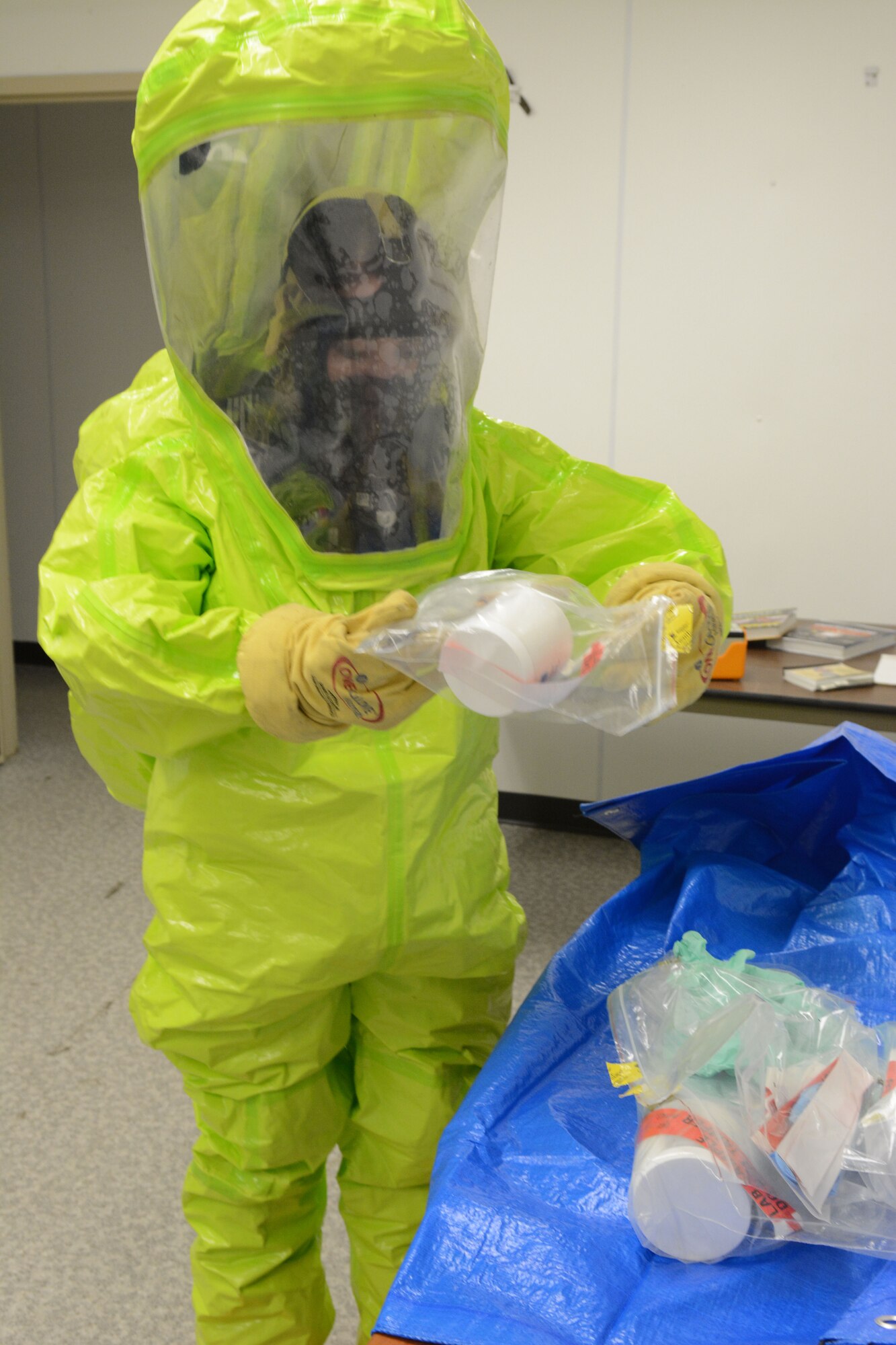 Senior Airman Sara Passint, 133rd emergency management, prepares to remove samples from a contaminated area during a field training exercise at Volk Field Air National Guard Base, Wis., April 4, 2014. Twenty-eight Airmen teamed up from six units for training that encompassed all hazard responses including radiation, chemical and biological situations. The training was part of emergency management’s annual training requirement. (Air National Guard photo by Senior Airman Andrea F. Liechti)