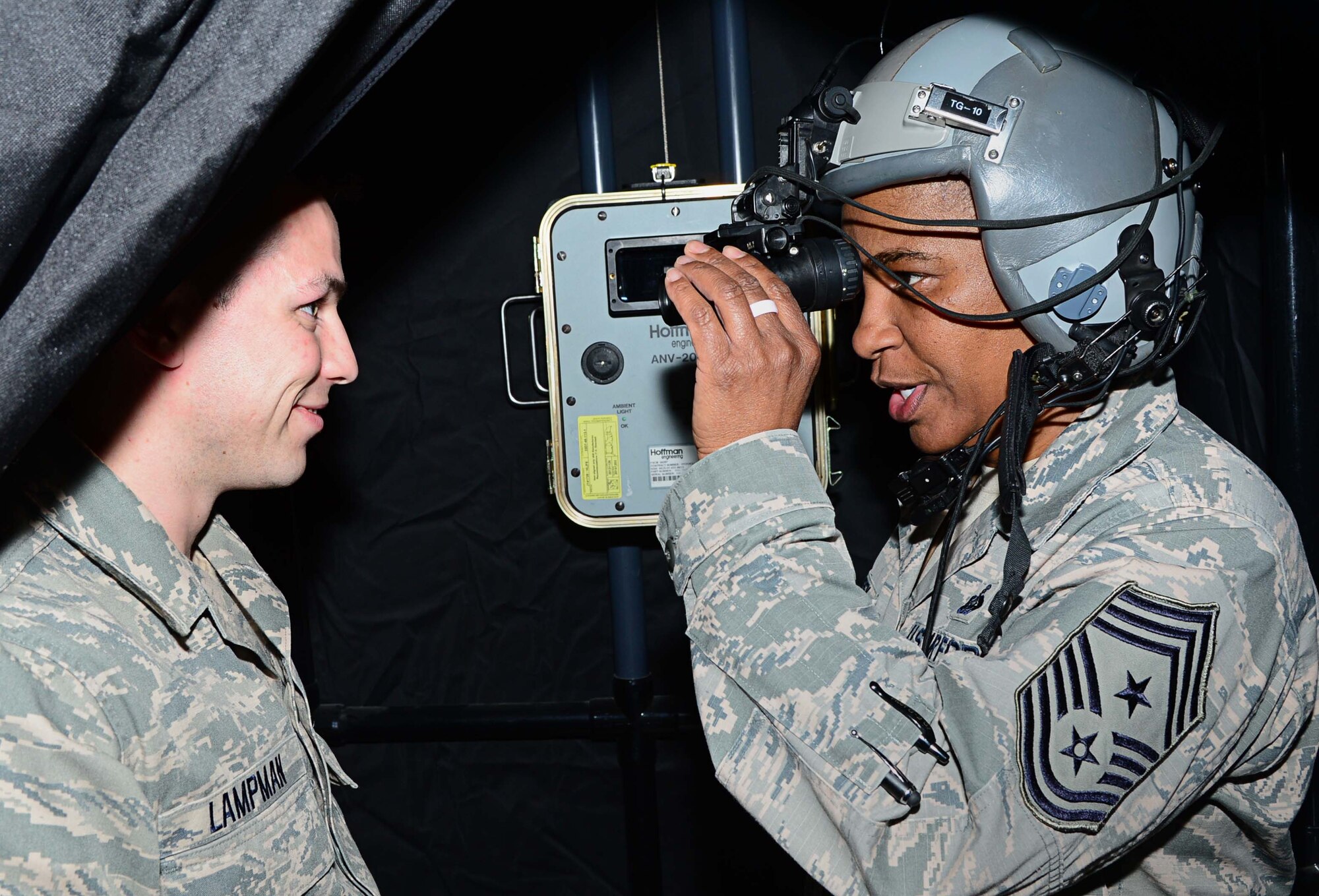 Senior Airman Andrew Lampman, 386th Expeditionary Operations Support
Squadron aircrew flight equipment, briefs Air Forces Central Command Chief Master
Sgt. Shelina Frey on the proper wear of a HGU-55/P flyer helmet and night
vision goggles during her farewell tour of the 386th Air Expeditionary Wing
at an undisclosed location in Southwest Asia. Frey met with and recognized numerous Airmen for their continuous service to the U.S. Air Force during Operation Enduring
Freedom. (U.S. Air Force photo by Senior Airman Desiree W. Moye)
