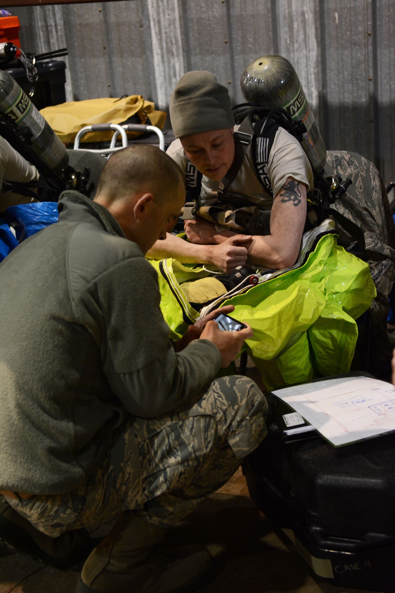 Tech. Sgt. Brian Black, 148th emergency management, briefs Staff Sgt. Ryan Dunlap, 127th emergency management on the objectives of the response prior to suiting up during a field training exercise at Volk Field Air National Guard Base, Wis., April 4, 2014. Dunlap was part of the second team to go into the training facility, so was responsible for gathering samples in the contaminated area during the exercise. The training exercise was part of emergency management’s annual training requirement. (Air National Guard photo by Senior Airman Andrea F. Liechti)