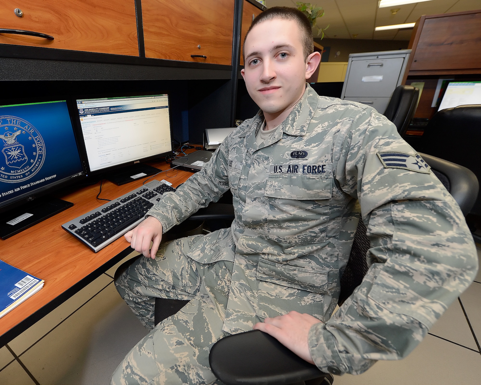Senior Airman Ryan Lee, 436th Communications Squadron knowledge operations manager, poses at his work station March 28, 2014, at Dover Air Force Base, Del. Lee traveled to the Pentagon to present his Appointment Letter Management Tool and process to high ranking Air Force officials. (U.S. Air Force photo/Greg L. Davis)