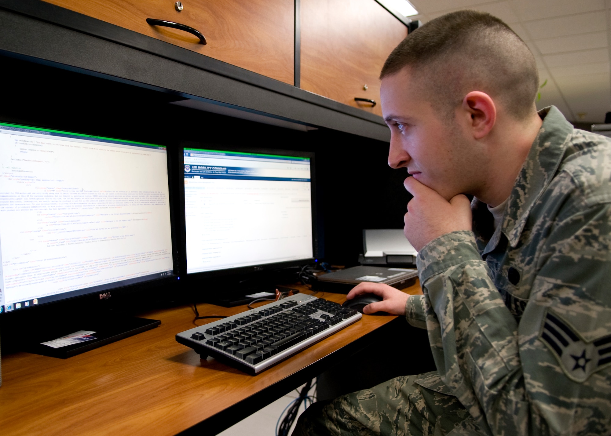 Senior Airman Ryan Lee, 436th Communications Squadron knowledge operations manager, examines computer code April 3, 2014, at Dover Air Force Base, Del. Lee spent more than a year creating and building a new process using the Appointment Letter Management Tool. (U.S. Air Force photo/Airman 1st Class Zachary Cacicia)