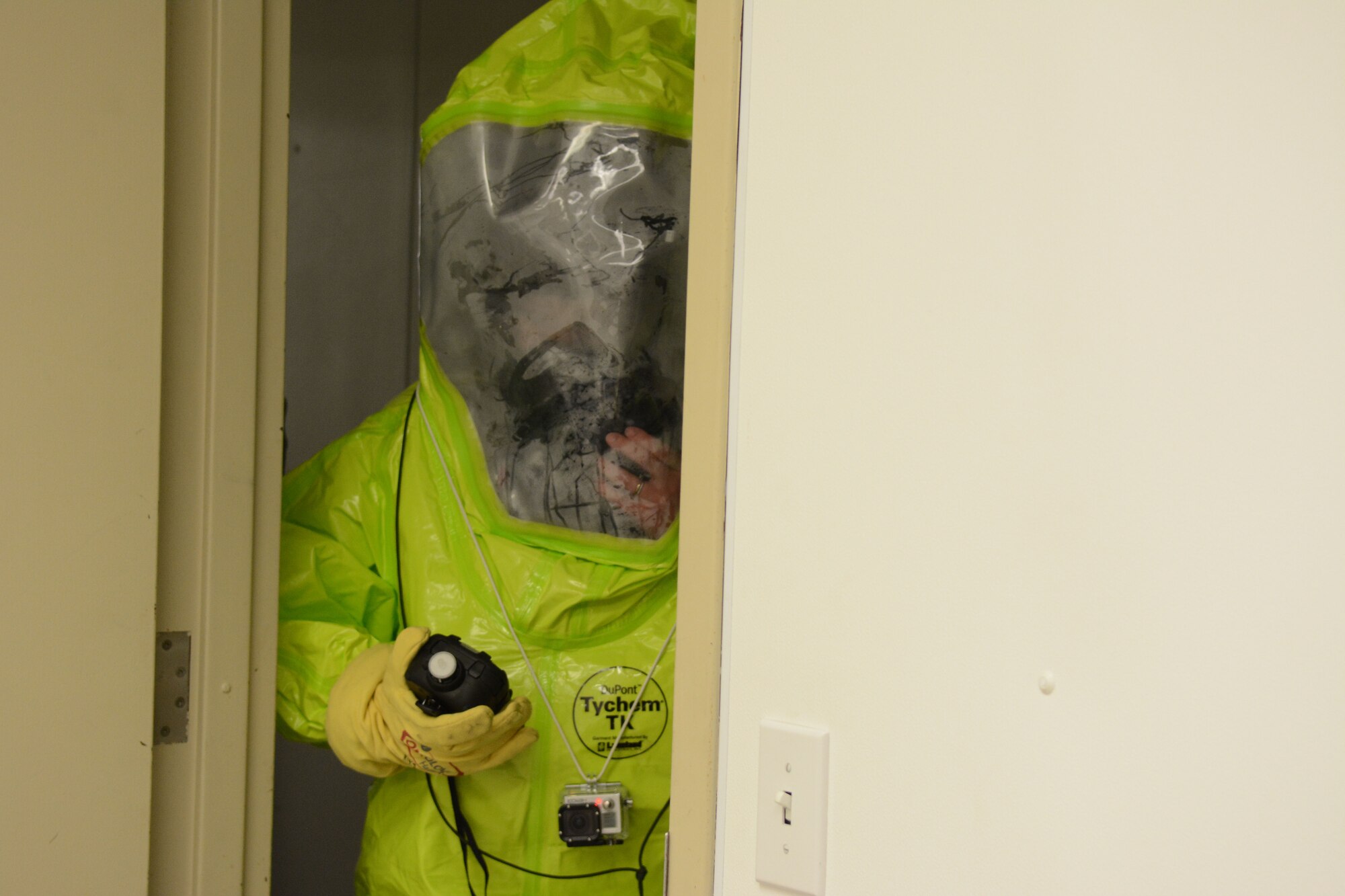Senior Airman Elisabeth Adkins, 934th emergency management, monitors a room prior to entry during a field training exercise at Volk Field Air National Guard Base, Wis., April 4, 2014. Their goal was to scan the facility for anything suspicious and document everything they saw so that teams going in after they came out could be more prepared for the biological, chemical or radiation situations inside. The training was part of emergency management’s annual training requirement. (Air National Guard photo by Senior Airman Andrea F. Liechti)