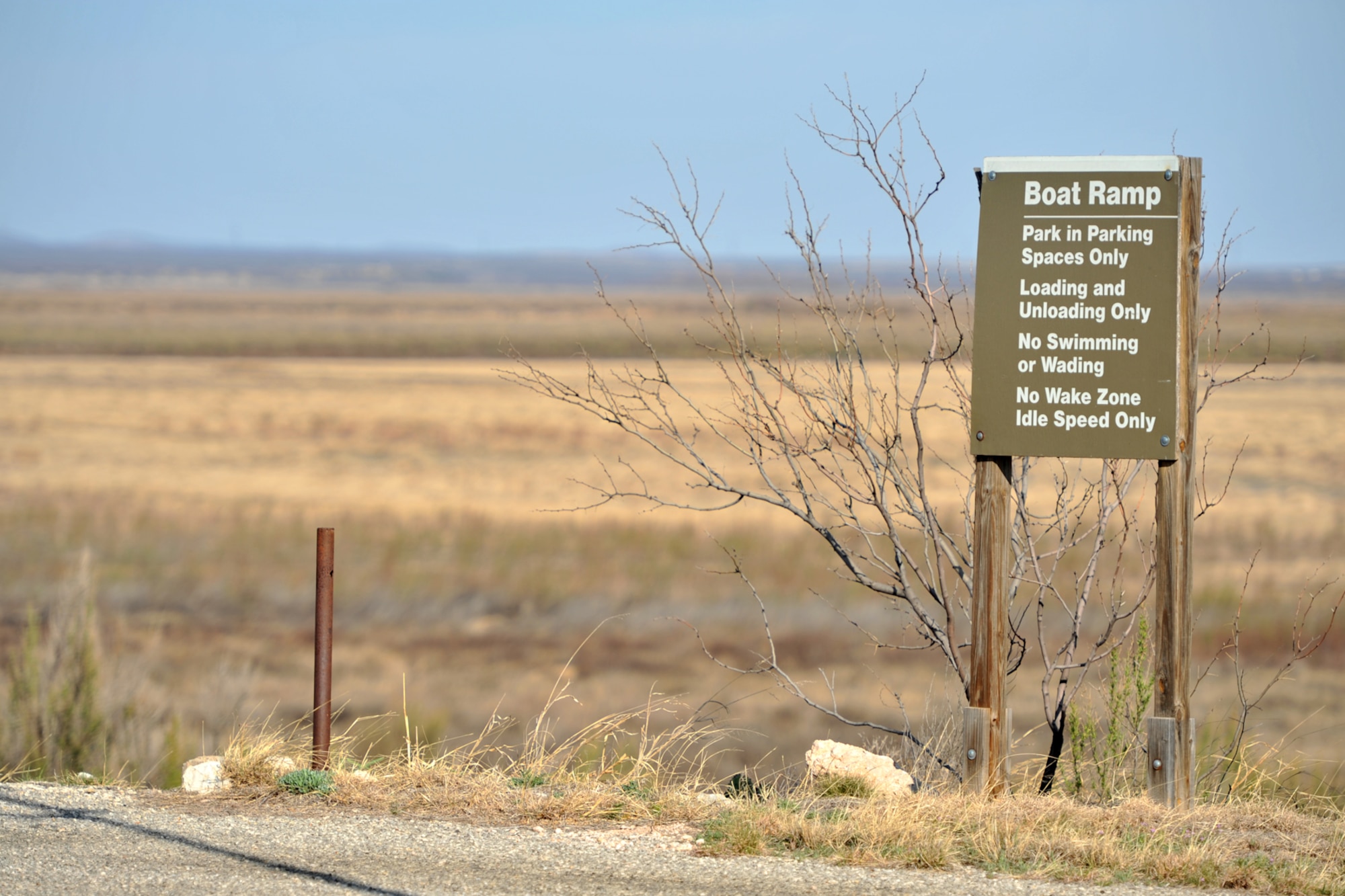 SAN ANGELO, Texas – A boat ramp sign stands outside the dried O.C. Fisher Reservoir which is filled with plant life March 27. The reservoir is only 0.6 percent full as of April 3. (U.S. Air Force Photo/ Airman 1st Class Devin Boyer)