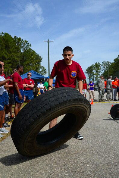 U.S. Air Force Airman from the 20th Force Support Squadron, flips a tire at the 20th Mission Support Group Warrior Challenge at Shaw Air Force Base, S.C., April 4, 2014. Several events during the crossfit challenge were held throughout the day to test Airmen’s strength and agility. (U.S. Air Force photo by Airman 1st Class Michael A. Cossaboom)