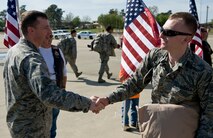 Col. Lamar Pettus, 4th Fighter Wing vice commander, welcomes home Senior Airman Joshua Sears, 4th Equipment Maintenance Squadron repair and reclamation technician, from a deployment, April 5, 2014, at Seymour Johnson Air Force Base, N.C.  Sears, along with nearly 300 other Airmen, were deployed to the 380th Air Expeditionary Wing in Southwest Asia to enhance regional partnerships, support security exercises, and demonstrate a continued commitment to area security and stability.  (U.S. Air Force photo/Airman 1st Class Brittain Crolley)
