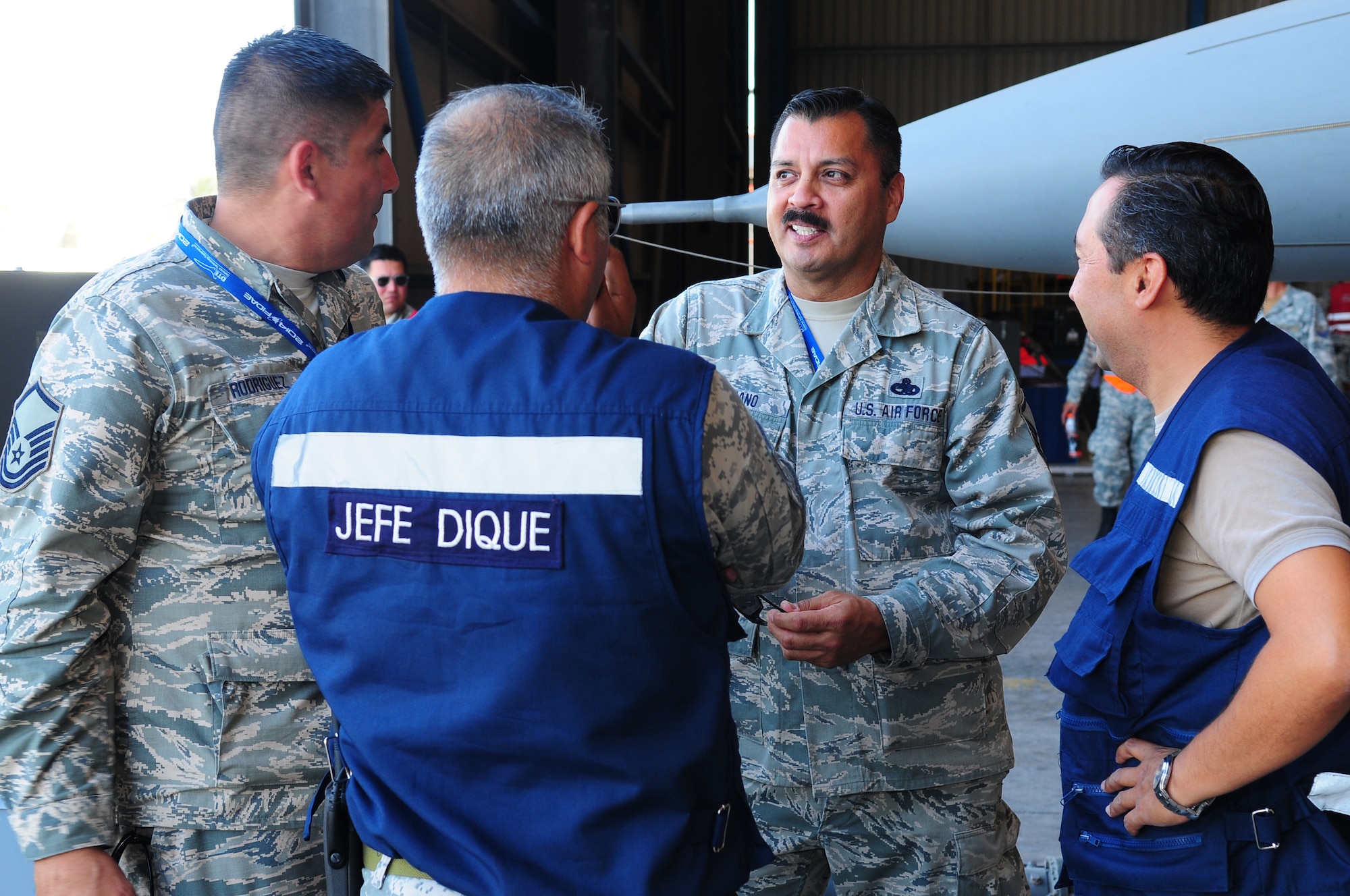 Master Sgt. Pete Soriano (second from right), an F-16 avionics specialist assigned to the 149th Fighter Wing, Texas Air National Guard, exchanges maintenance practices with his counterparts from FACH (Fuerza Aerea de Chile) during FIDAE (Feria Internacional del Aire y del Espacio), an international trade exhibition air and space show, in Santiago, Chile, March 25, 2014. Also pictured is Master Sgt. Carlos Rodriguez (left), an F-16 crew chief assigned to the 149th Fighter Wing. Members of the Texas Air National Guard were in Chile as part of the National Guard Bureau's State Partnership Program. (U.S. Air National Guard photo by Senior Master Sgt. Miguel D. Arellano / Released)
