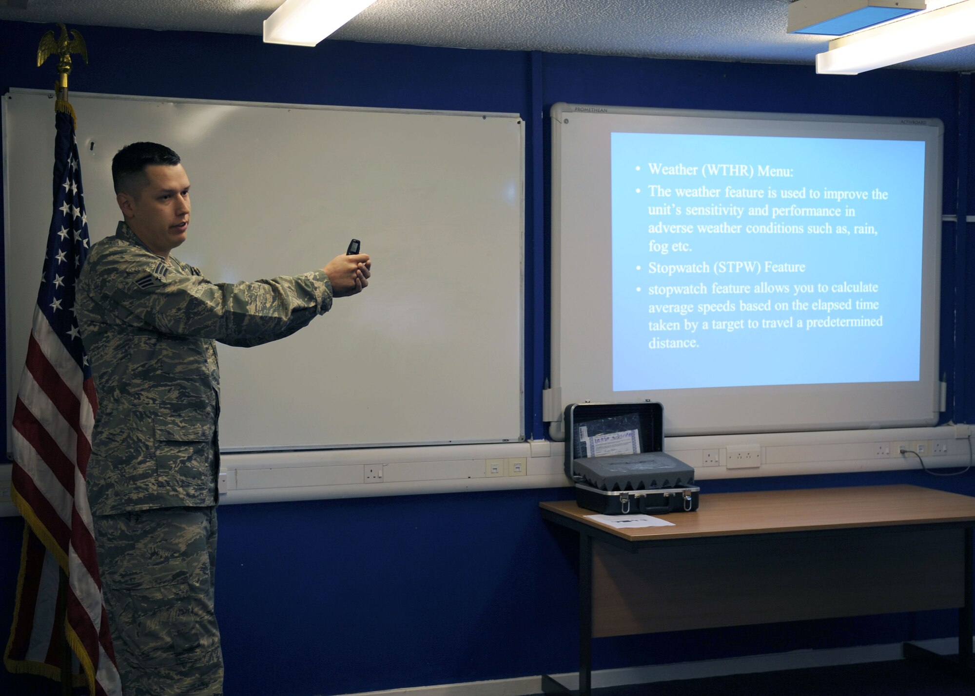 U.S. Air Force Senior Airman Tyler Adams, 100th Security Forces Squadron trainer from Grasslake, Mich., demonstrates proper posture while using an infrared light radar system April 8, 2014, on RAF Mildenhall, England. During a class, Adams briefed 100th SFS Airmen on the purpose, basic use, troubleshooting and overall importance of the system. U.S. Air Force Chief Master Sgt. Tracy Jones, 100th Air Refueling Wing command chief, attended the class as part of the Dirty Jobs program before helping Adams catch unsafe drivers on RAF Mildenhall. (U.S. Air Force photo by Airman 1st Class Preston Webb/Released)