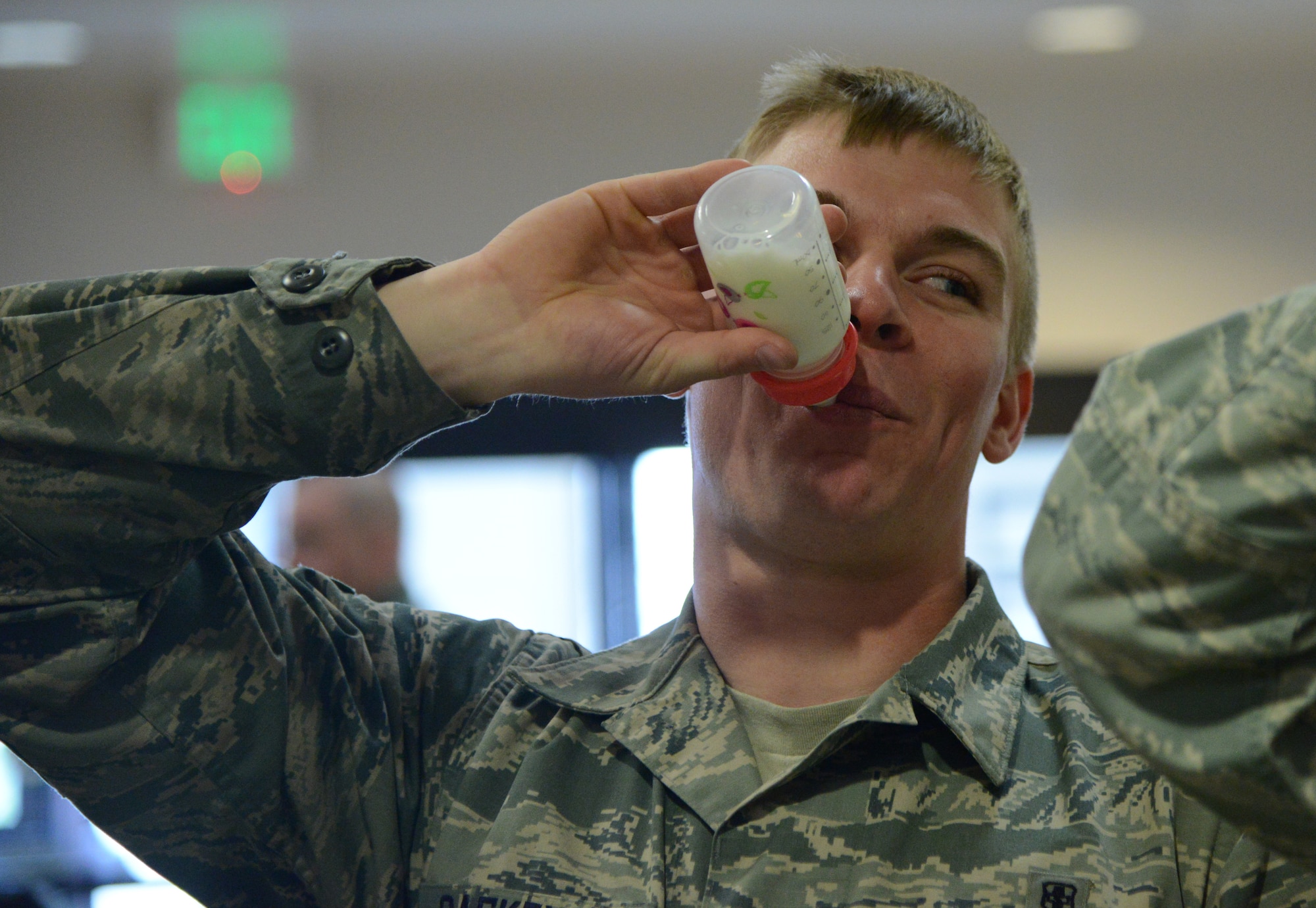 PETERSON AIR FORCE BASE, Colo. – Airman 1st Class Derric Caskey, 21st Medical Support Squadron, participates in the Public Health Week milk drinking contest at the Peterson Clinic April 7. Caskey won the competition by finishing his bottle in less than five minutes. The contest was one of several events designed to raise awareness of public health. (U.S. Air Force photo/Tech. Sgt. Jared Marquis)