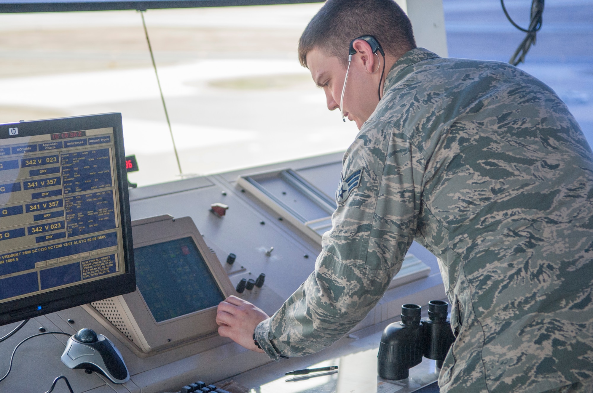 Senior Airman Brent Sargent, 436th Operations Support Squadron air traffic control tower controller, talks to other facilities April 2, 2014, at Dover Air Force Base, Del. Sargent uses the Enhanced Terminal Voice System to communicate with other facilities such as radar approach control, airfield management and Federal Aviation Administration personnel. (U.S. Air Force photo/Senior Airman Jared Duhon)