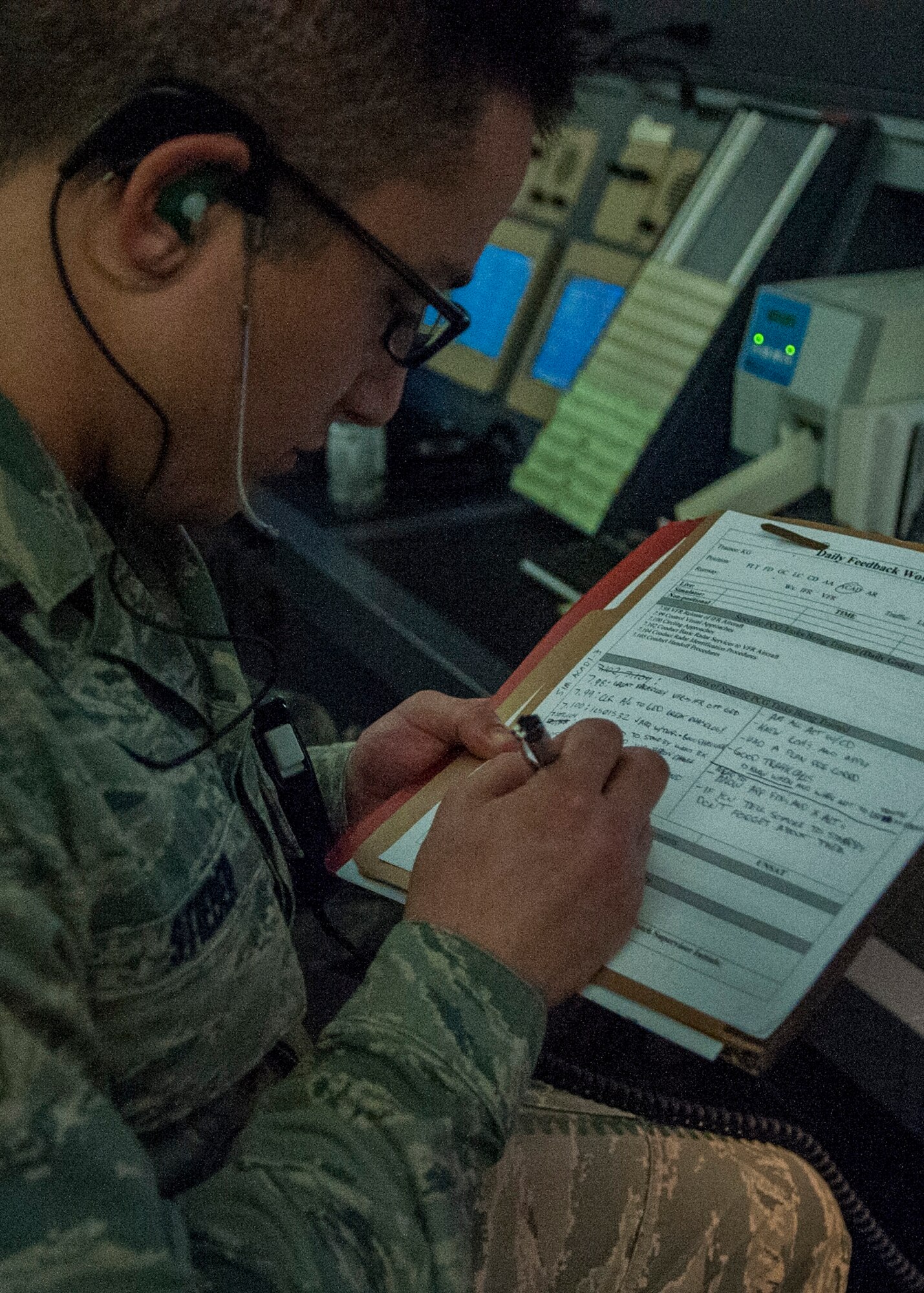 Senior Airman Adam Stieber, 436th Operations Support Squadron air traffic control radar approach controller, fills out information for a weekly training evaluation April 2, 2014, at Dover Air Force Base, Del. Stieber is required to write weekly training evaluations based on the trainee’s performance.  (U.S. Air Force photo/Senior Airman Jared Duhon)