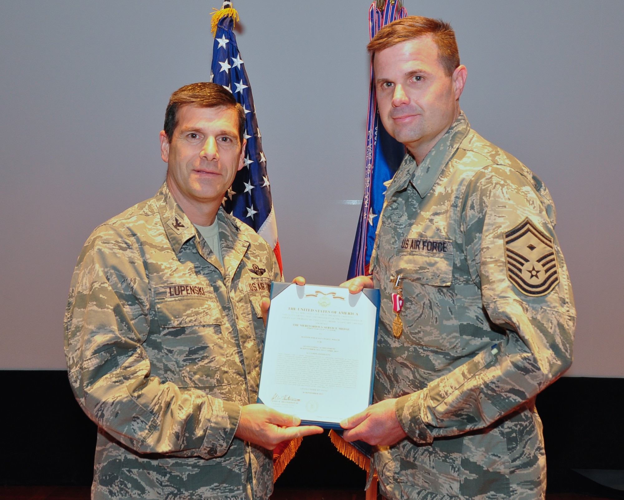 Commander of the 932nd Airlift Wing, Col. Albert Lupenski, presents Senior Master Sgt. Chad Welch with a Meritorious Service Medal for dedication to the unit and his outstanding work overseas.  Sergeant Welch is a member of the 932nd Aeromedical Evacuation Squadron.  (U.S. Air Force photo/SSgt. Amber Hodges)