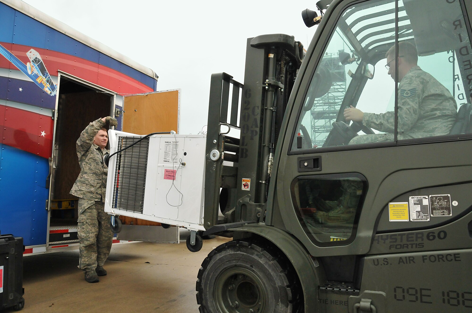 Master Sgt. Nathan Lukey (left) and Staff Sgt. Joseph Davis, members of the Joint Incident Sight Communications Capability Team, unload a generator during a 50-hour exercise at Springfield Air National Guard Base that showcased the base’s unique capabilities for incident awareness and assessment during domestic disasters, April 4-5. (U.S. Air National Guard Photo by Tech. Sgt. Lou Burton)