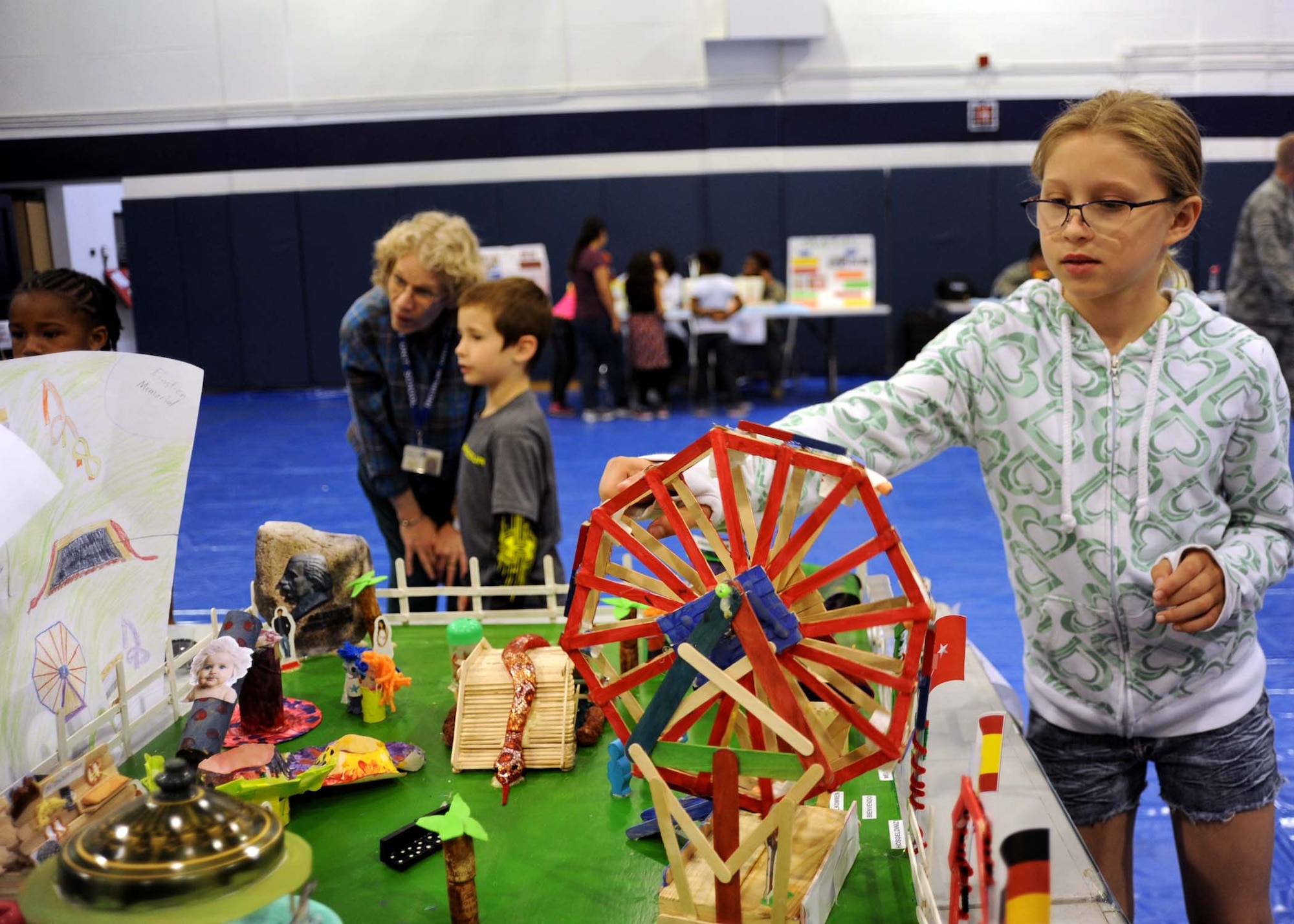INCIRLIK AIR BASE, Turkey—Skyla, an Incirlik Unit School fifth-grade student, demonstrates how Science, Technology, Engineering, and Math is used to operate an amusement park with her class’ model project called “Ecostien’s Park” at the IUS STEM fair April 4, 2014, Incirlik Air Base, Turkey. The fair gave students a chance to exhibit what they have learned throughout the school year and an opportunity to see how STEM is applied to real-world situations. (U.S. Air Force photo by Staff Sgt. Veronica Pierce)