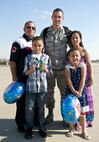 Tech. Sgt. Sean Douglas, 4th Aircraft Maintenance Squadron crew chief, poses for a group photo with his family after returning from a deployment, April 5, 2014, at Seymour Johnson Air Force Base, N.C.  Douglas spent several months away from his family and returned just before the birth of his third child, a baby girl.  (U.S. Air Force photo/Airman 1st Class Brittain Crolley)