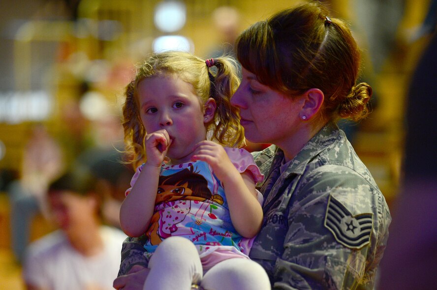 U.S. Air Force Tech. Sgt. Erika Stein, 52nd Fighter Wing executive assistant to the command chief and from Pittsburgh, holds her daughter, Chloe, during the Imagination Movers concert at the Skelton Memorial Fitness Center, Spangdahlem Air Base, Germany, April 7, 2014. The band performed for approximately one hour before signing autographs for the children after the show. (U.S. Air Force photo by Airman 1st Class Kyle Gese/Released) 