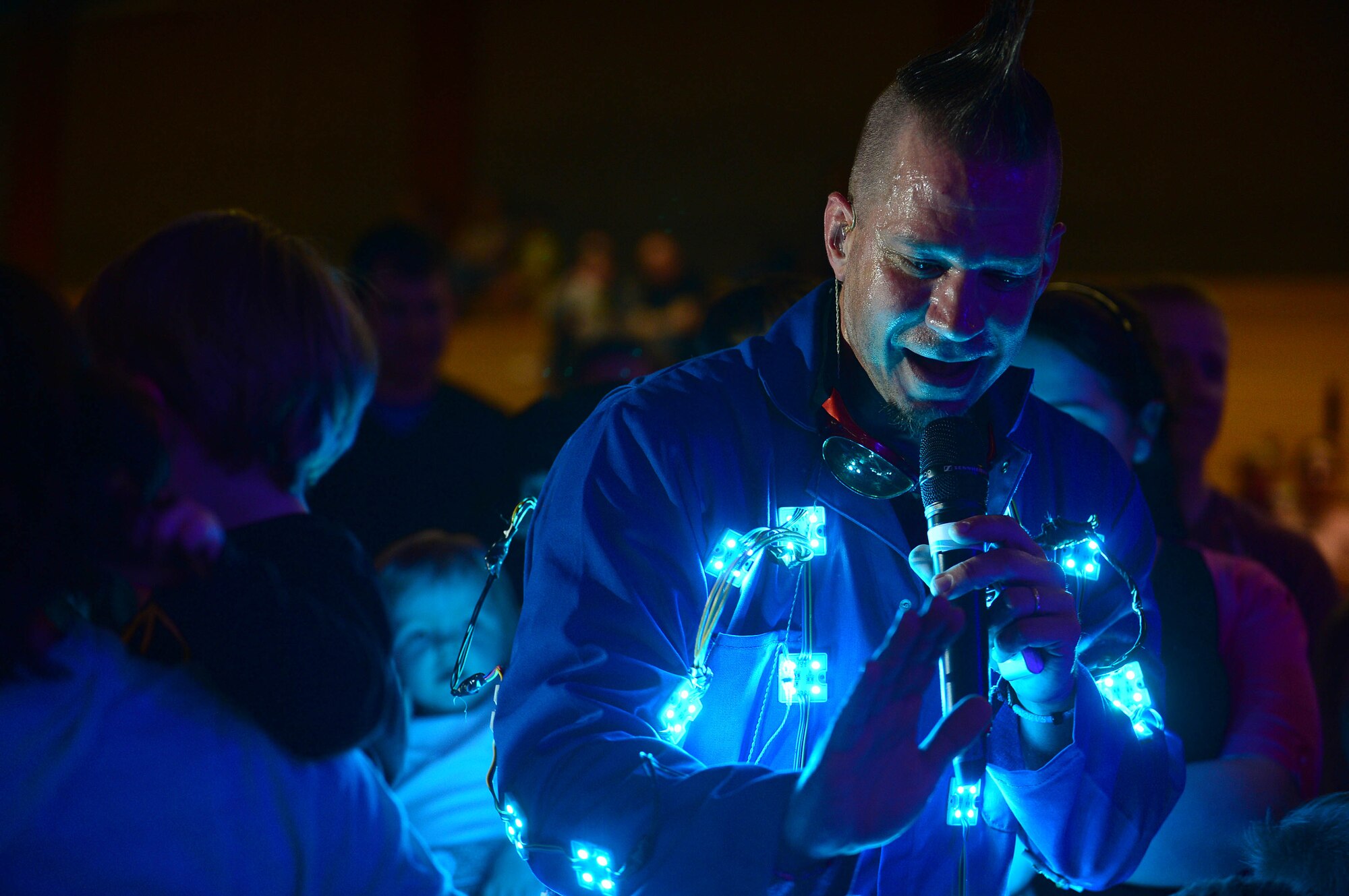 Scott Durbin, an Imagination Movers member, wears a light up suit and interacts with the audience at the Skelton Memorial Fitness Center, Spangdahlem Air Base, Germany, April 7, 2014. Imagination Movers wrote their songs to help children overcome fears and solve problems. (U.S. Air Force photo by Airman 1st Class Kyle Gese/Released)