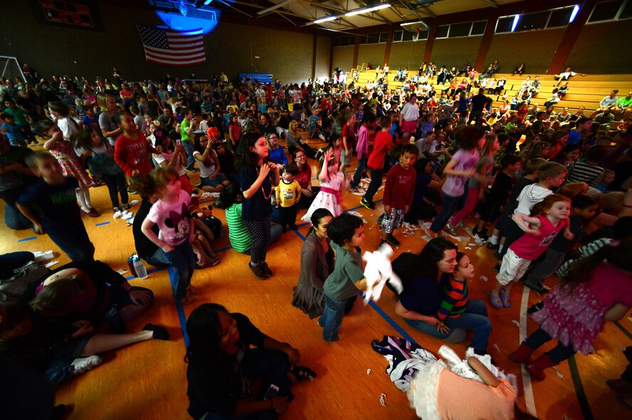 Children listen as Imagination Movers perform a song at the Skelton Memorial Fitness Center, Spangdahlem Air Base, Germany, April 7, 2014. Armed Forces Entertainment and the 52nd Force Support Squadron brought the group to Spangdahlem to perform a free concert. (U.S. Air Force photo by Airman 1st Class Kyle Gese/Released)