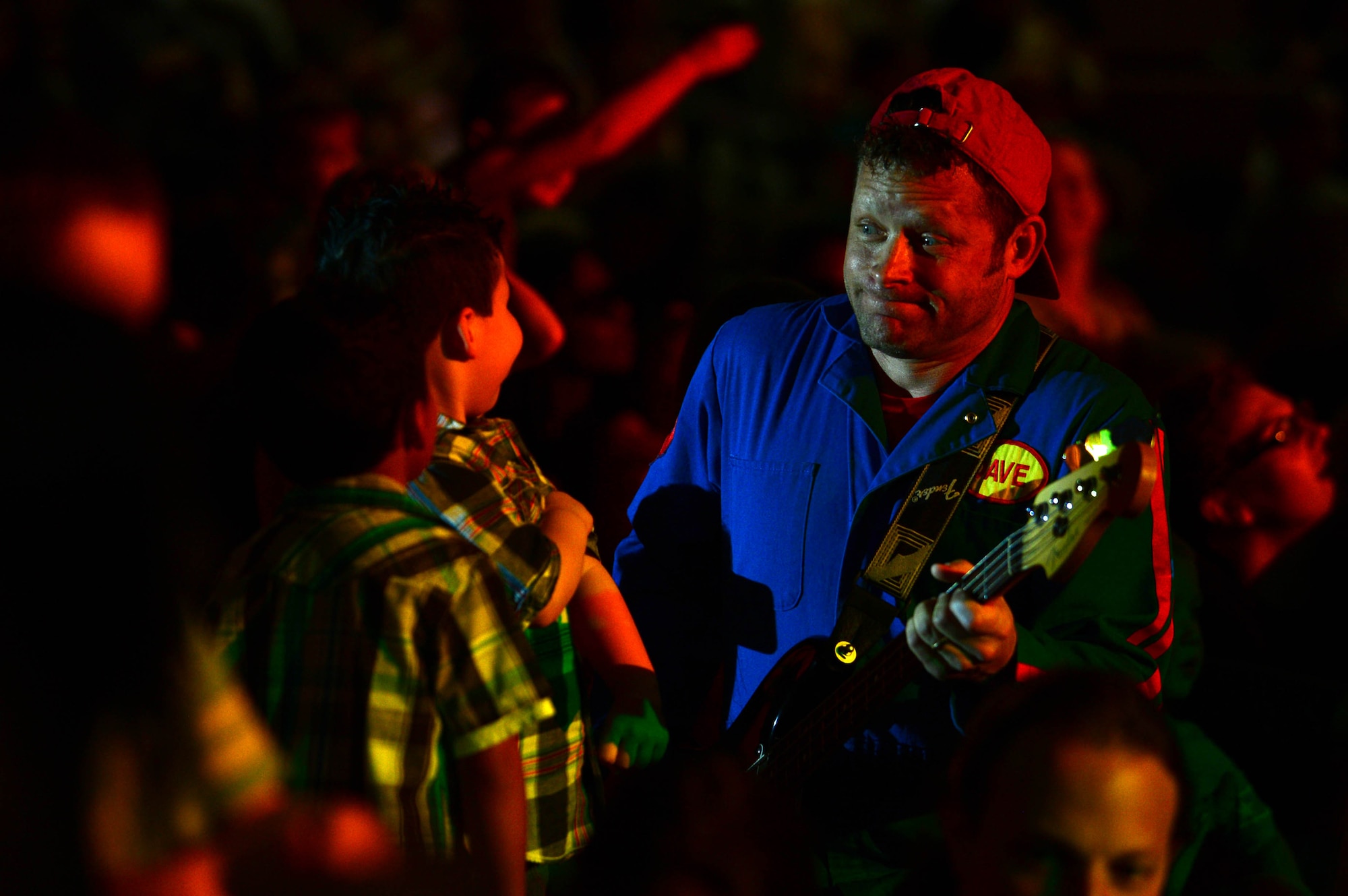 Dave Poche, an Imagination Movers member, plays his bass guitar in an audience of more than 400 people at the Skelton Memorial Fitness Center, Spangdahlem Air Base, Germany, April 7, 2014. Imagination Movers began in 2003 when a group of friends wrote bedtime songs for their children. (U.S. Air Force photo by Airman 1st Class Kyle Gese/Released)
