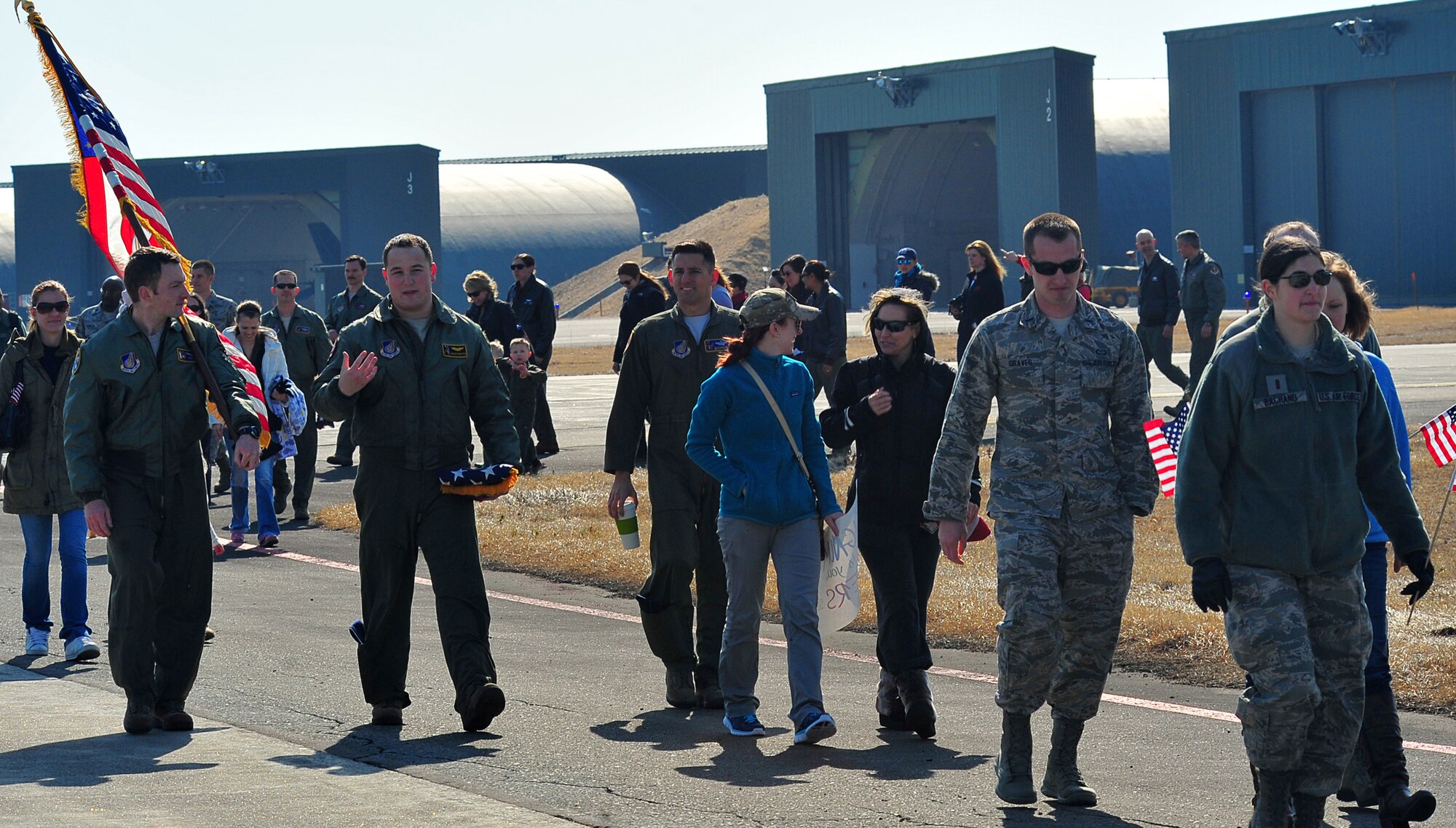Friends and family members of the 13th Fighter Squadron return to their transport vehicles after bidding farewell to the team of F-16 Fighting Falcons headed for deployment. Families were given the unique opportunity of seeing their loved ones fly-off directly from the flightline. (U.S. Air Force photo/Senior Airman Jose L. Hernandez-Domitilo)