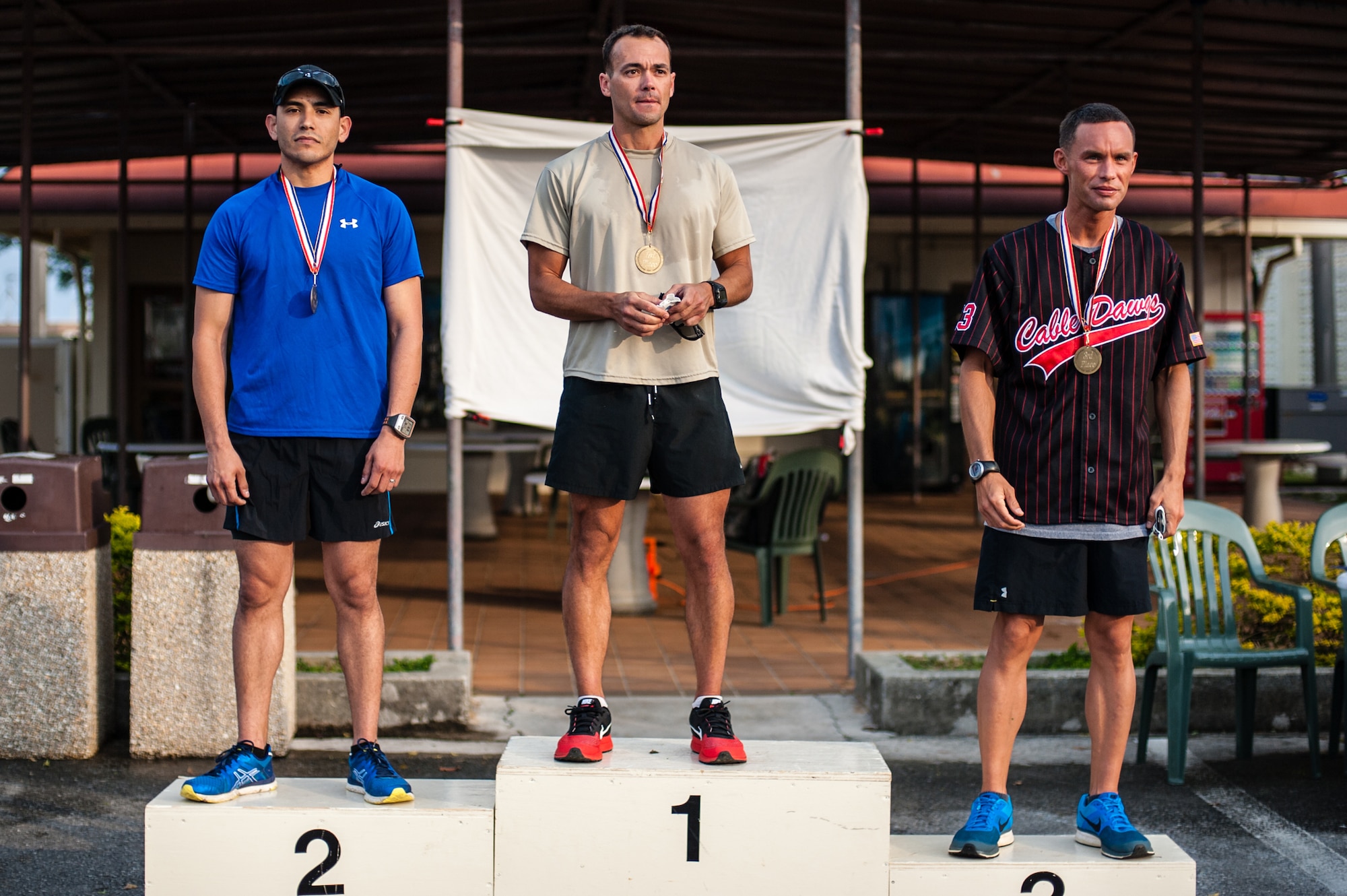 The first three male runners to cross the finish line of the Air Force Assistance Fund Habu Trail 6.5K are: Shawn O'Conner, a contractor with the 320th Special Tactics Squadron, in first place with 27 minutes; Staff Sgt. Gene Davila, an 18th Aerospace Medicine Squadron bioenvironmental engineer technician, in second place with 27:12; and Tech. Sgt. David Hollars, an 18th Communications Squadron cable and antenna systems supervisor, in third place with 28:18. The run was held to gather donations for the AFAF campaign on Kadena Air Base, Japan, April 4, 2014. (U.S. Air Force photo by Staff Sgt. Alexy Saltekoff)
